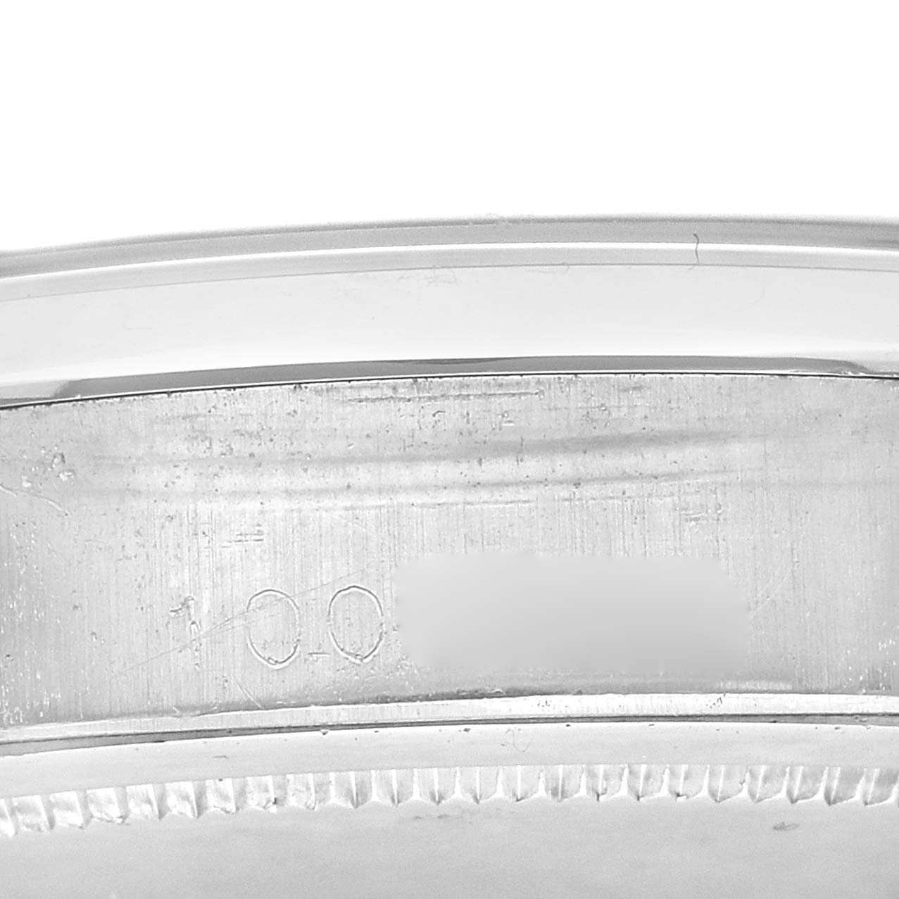 The image shows a close-up of the serial number on the side of the case of a Rolex Vintage Collection 6694 Men's Stainless Steel Silver Dial 6694 Men's Stainless Steel Silver Dial watch.