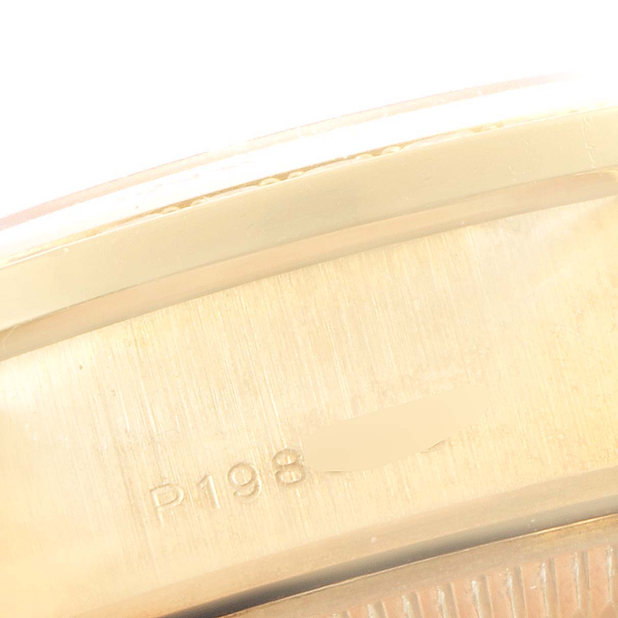 The image shows a close-up of the serial number engraving on the caseback of a Rolex President 79158 Women
s Yellow Gold Champagne Dial 79158 Women
s Yellow Gold Champagne Dial model watch.
