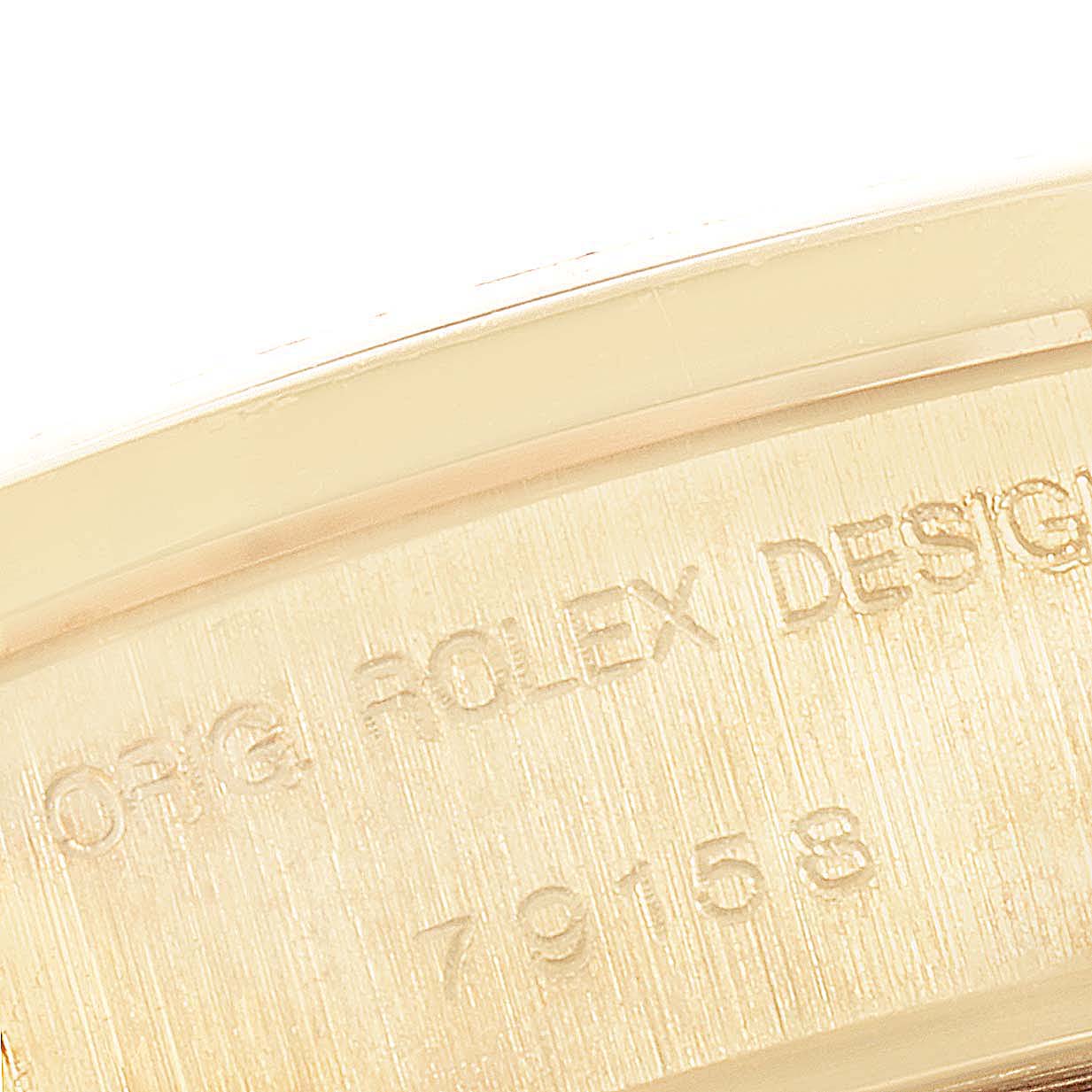 The image shows a close-up of text engraving on the case of a Rolex President 79158 Women
s Yellow Gold Champagne Dial 79158 Women
s Yellow Gold Champagne Dial model watch.