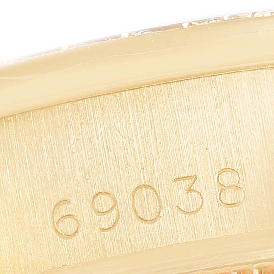 This close-up image shows the model number engraving on the case of a Rolex President 69038 Women's Yellow Gold Champagne Dial 69038 Women's Yellow Gold Champagne Dial watch.