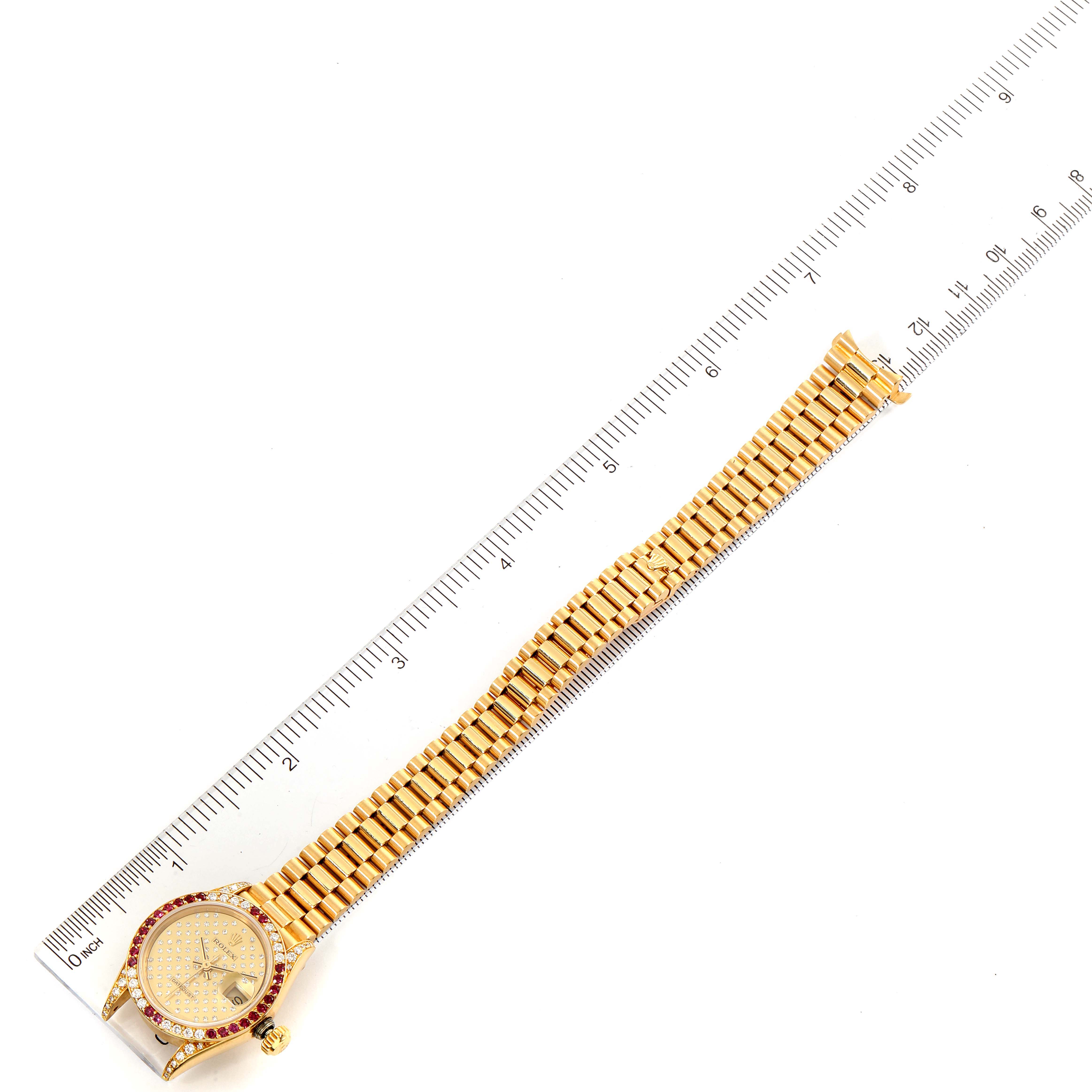 This image shows a top-down view of a Rolex President 69038 Women's Yellow Gold Champagne Dial 69038 Women's Yellow Gold Champagne Dial model watch, including the face and bracelet, placed next to a ruler.