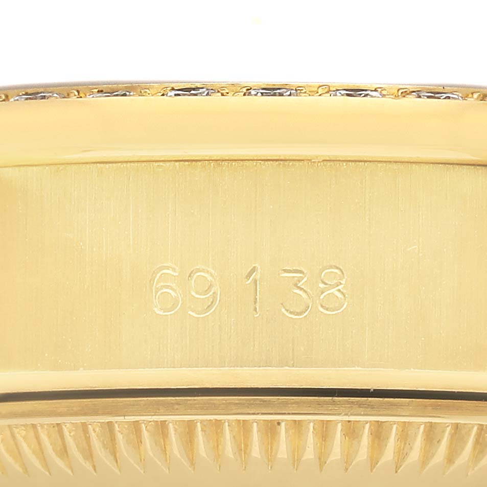 The image shows a close-up of the side of a Rolex President 69138 Women's Yellow Gold Champagne Dial model, highlighting its engraved model number.
