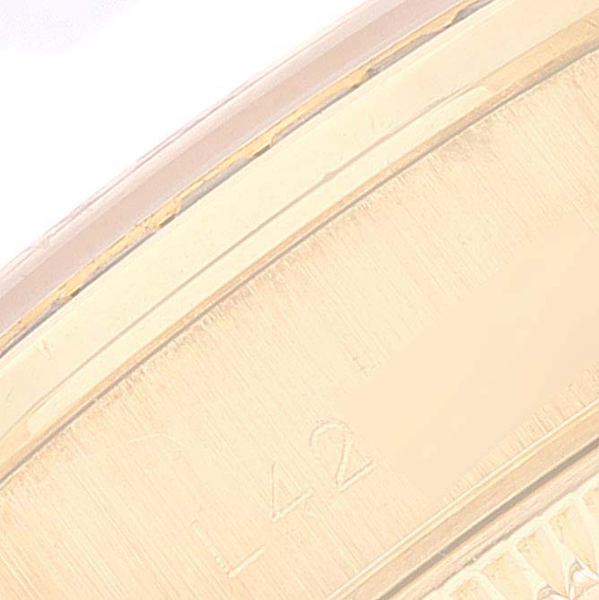 The image shows a close-up of the edge and engraving detail of the Rolex President 69028 Women's Yellow Gold Mother of Pearl Dial 69028 Women's Yellow Gold Mother of Pearl Dial model watch.