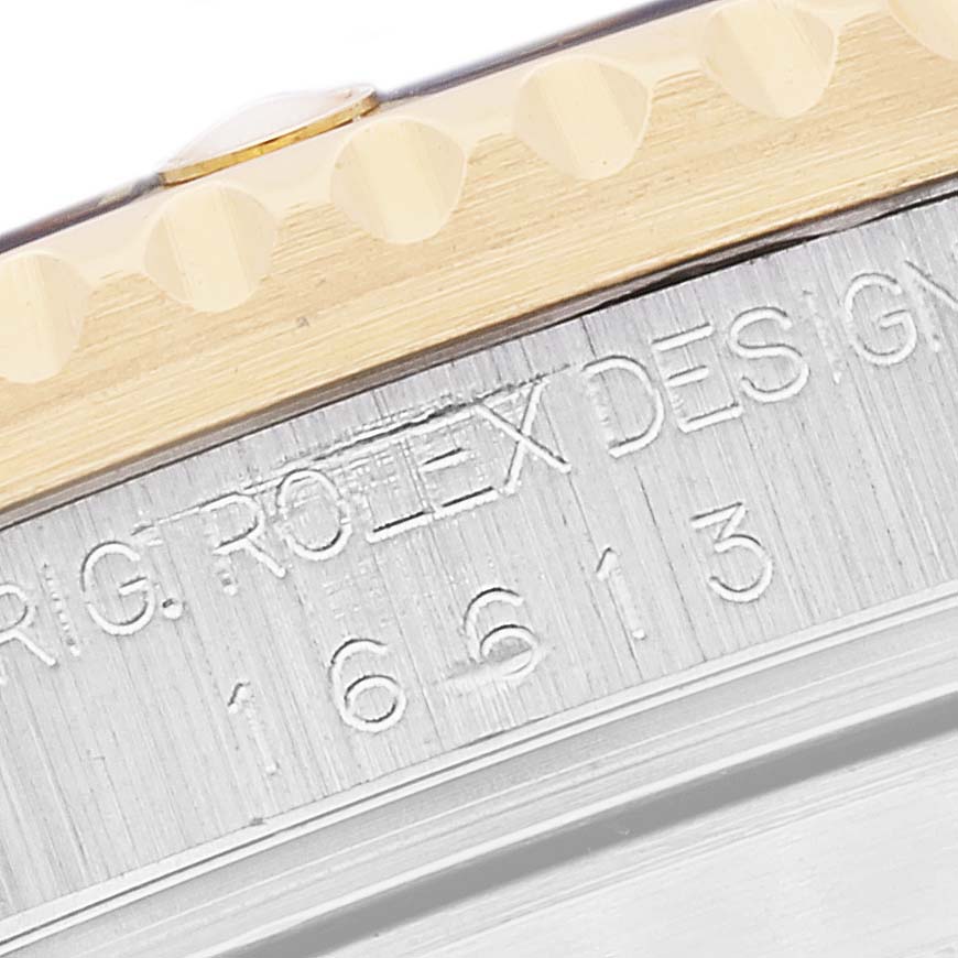 This close-up image shows the edge of the bezel and engraved model number on the case of a Rolex Submariner 16613 Men's Steel and Gold (two tone) Blue Dial 16613 Men's Steel and Gold (two tone) Blue Dial watch.