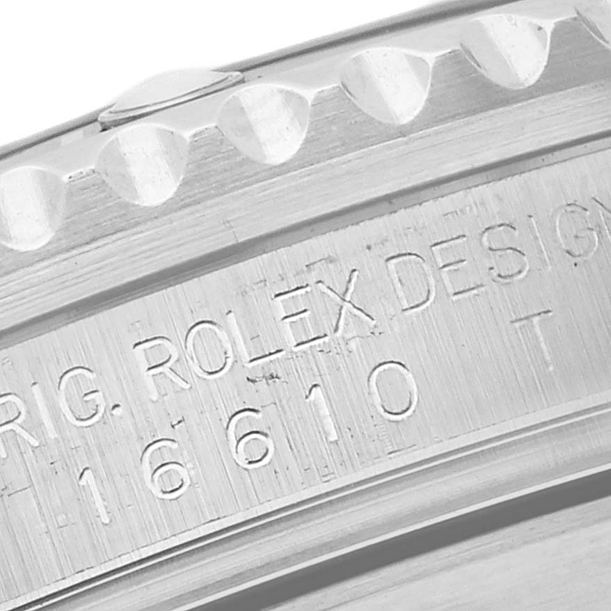 The image shows a close-up of the side of a Rolex Submariner 16610 Men
s Stainless Steel Black Dial 16610 Men
s Stainless Steel Black Dial watch case, featuring the model number and bezeled edge.