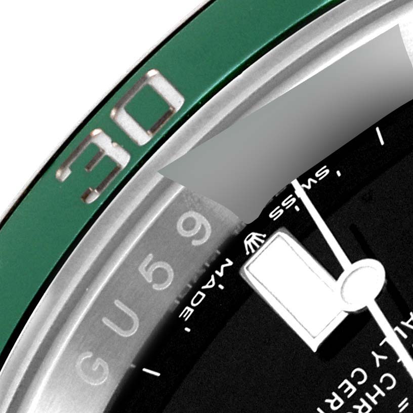 This close-up image of a Rolex Submariner 126610LV Men
s Stainless Steel Black Dial 126610LV Men
s Stainless Steel Black Dial watch shows part of the green bezel and a section of the dial, including the "30" marker.