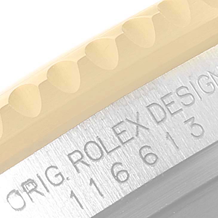 This close-up image of the Rolex Submariner 116613 Men's Steel and Gold (two tone) Black Dial 116613 Men's Steel and Gold (two tone) Black Dial watch shows a detailed view of the bezel and the engraved model number.