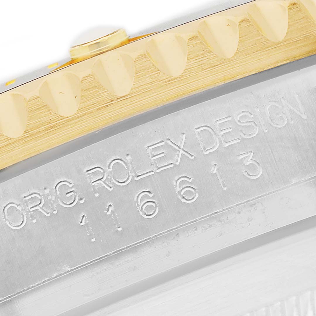 The image shows a close-up of the edge, bezel, and engraved serial number on a Rolex Submariner 116613LN Men's Steel and Gold (two tone) Black Dial watch.