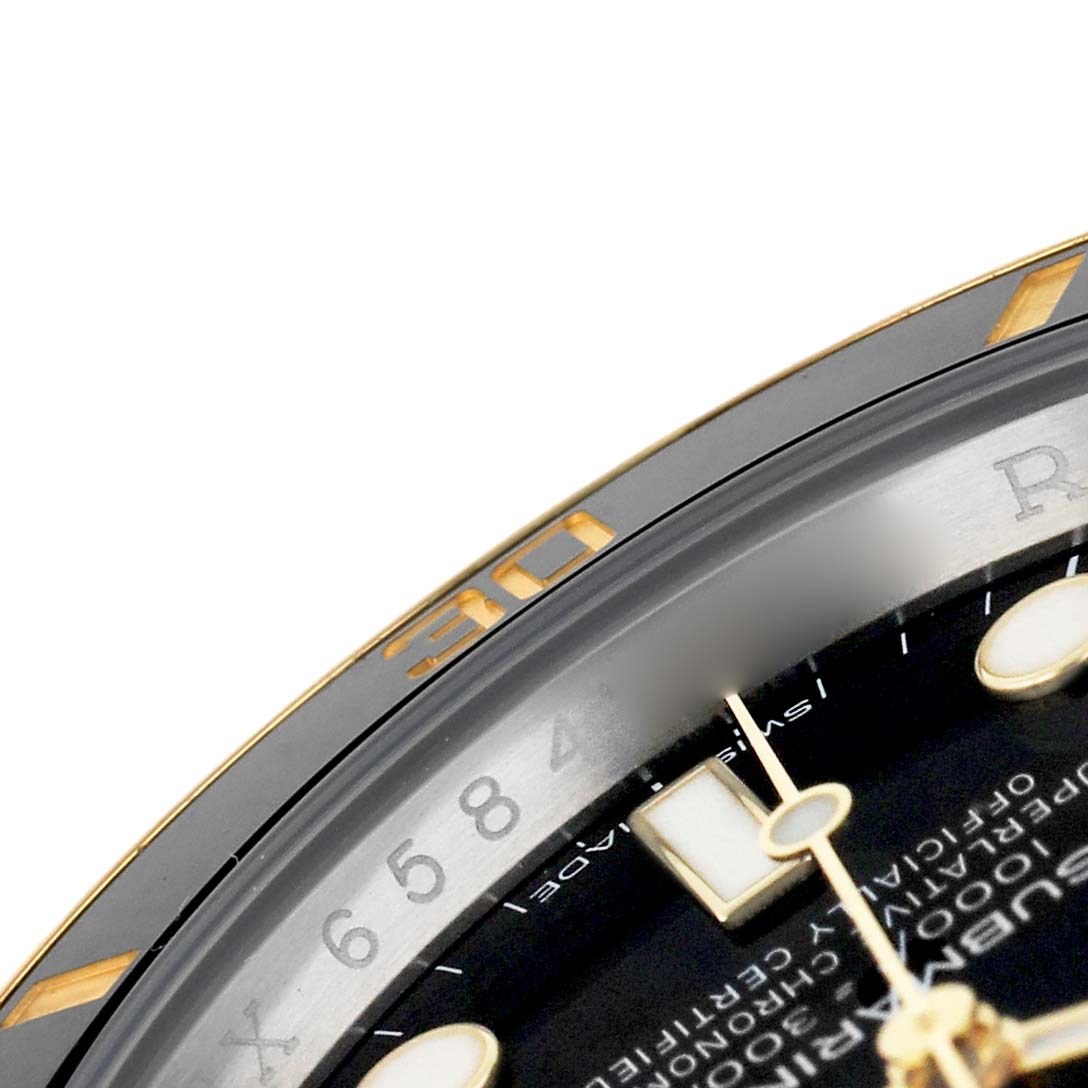 The image shows a close-up of a Rolex Submariner 116613LN Men's Steel and Gold (two tone) Black Dial watch, highlighting the bezel, part of the dial, and markers.