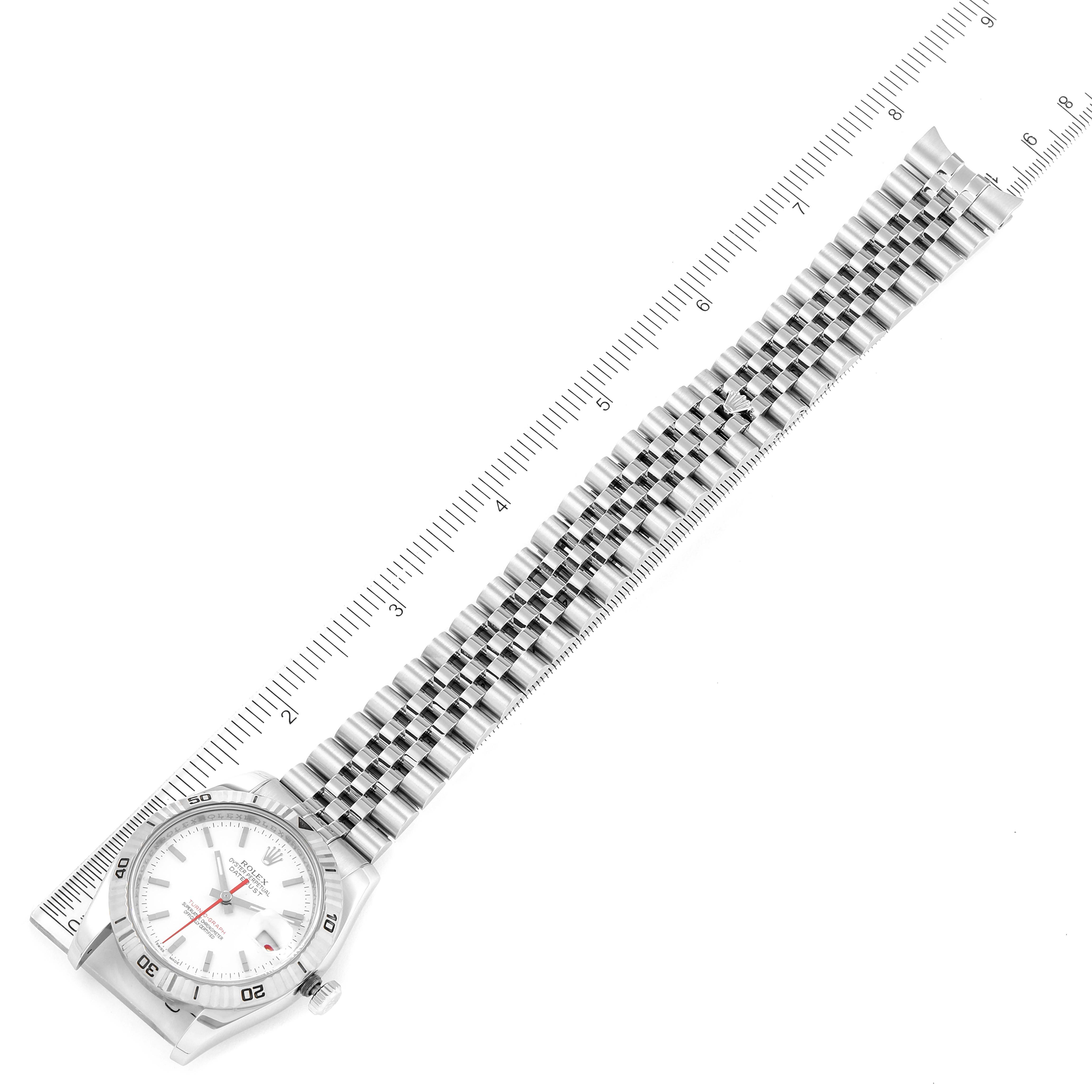 The image shows the Rolex Turn-o-Graph 116264 Men's Stainless Steel White Dial 116264 Men's Stainless Steel White Dial watch from a top-down angle displaying its face, bezel, and metal bracelet with a ruler beside it.
