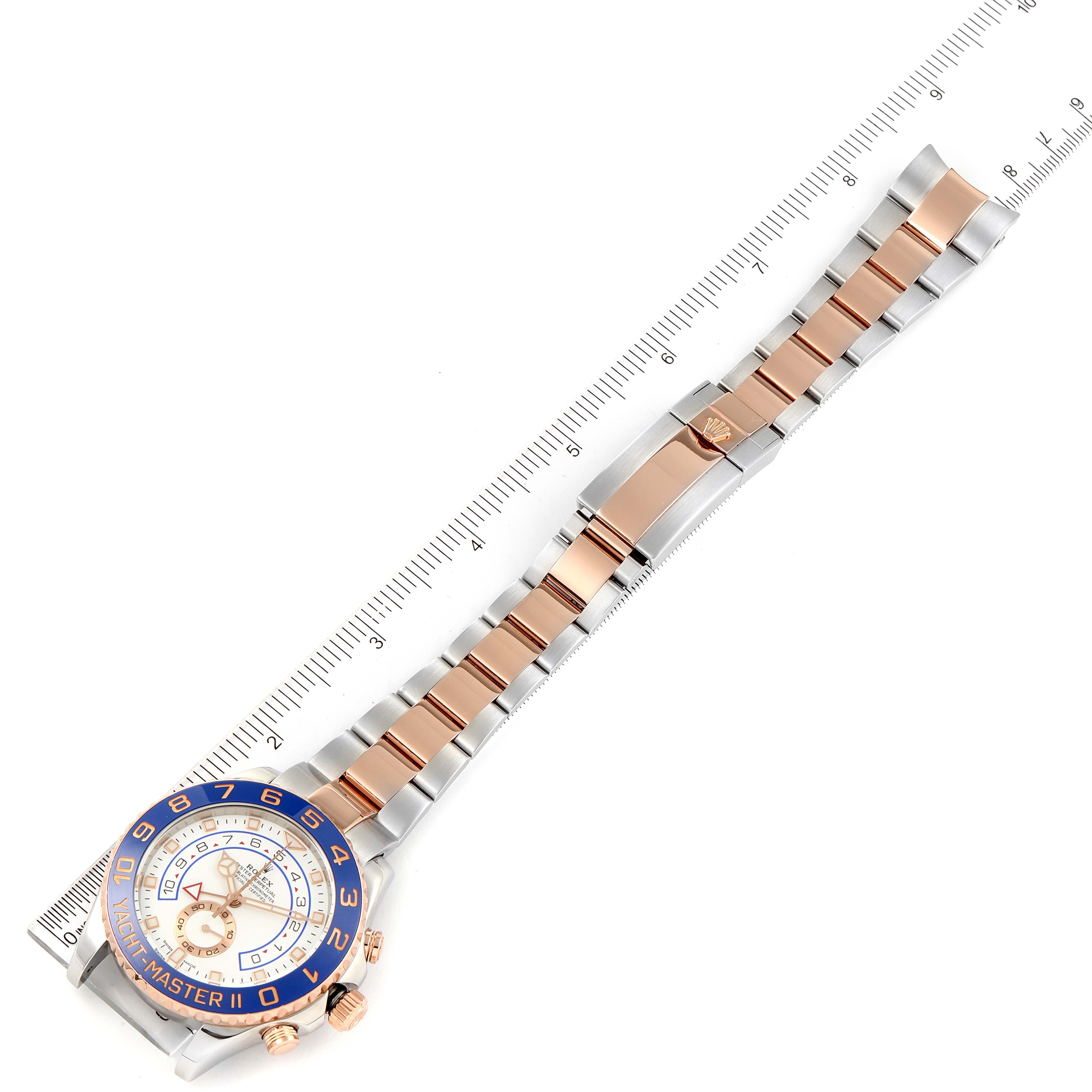 The image shows the full length of a Rolex Yacht-Master 116681 Men's Steel and Gold (two tone) White Dial 116681 Men's Steel and Gold (two tone) White Dial watch, including both the face and the bracelet, with a ruler for scale.