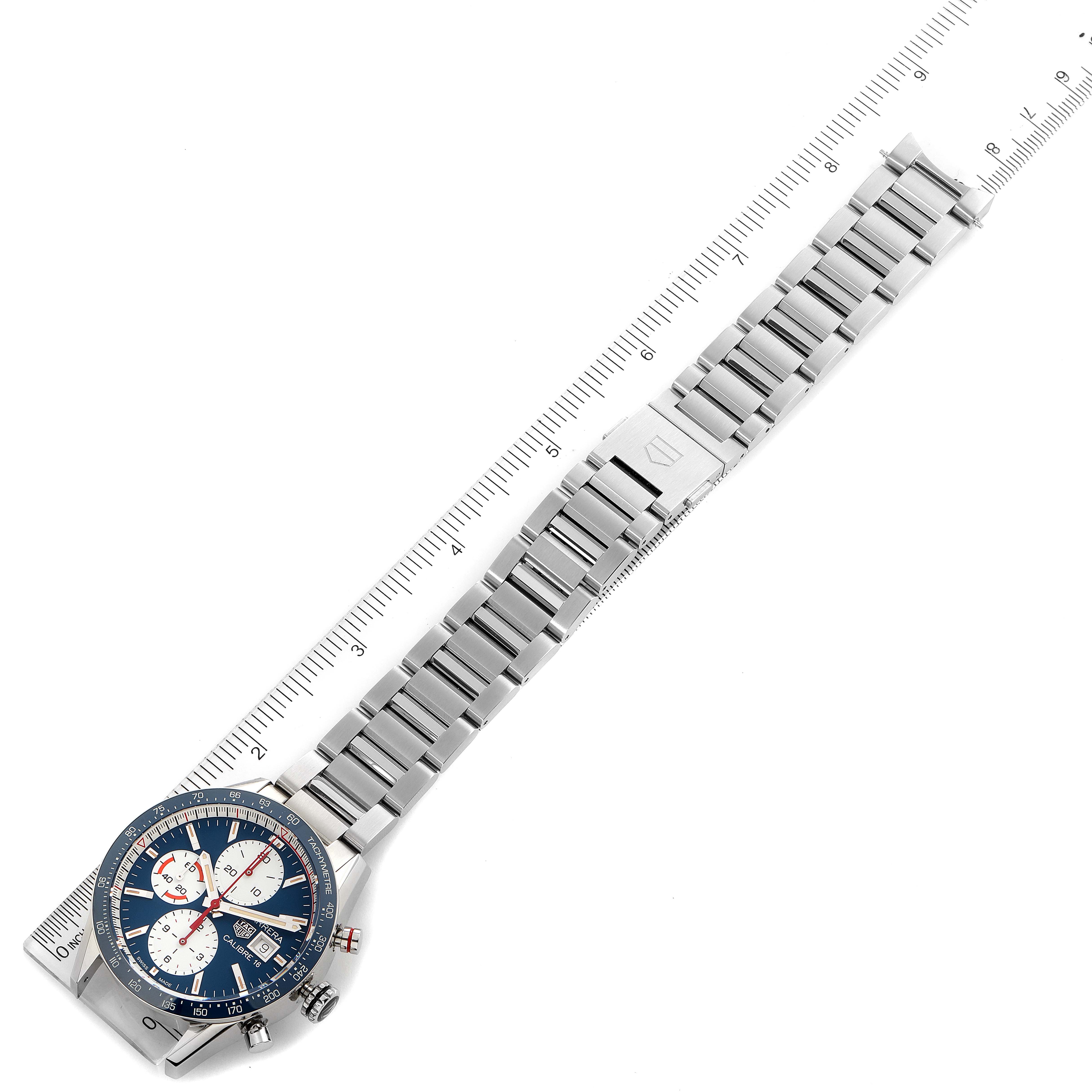 The watch shown is a Carrera model by Tag Heuer, displayed from an angled top view highlighting the dial and stainless steel bracelet.