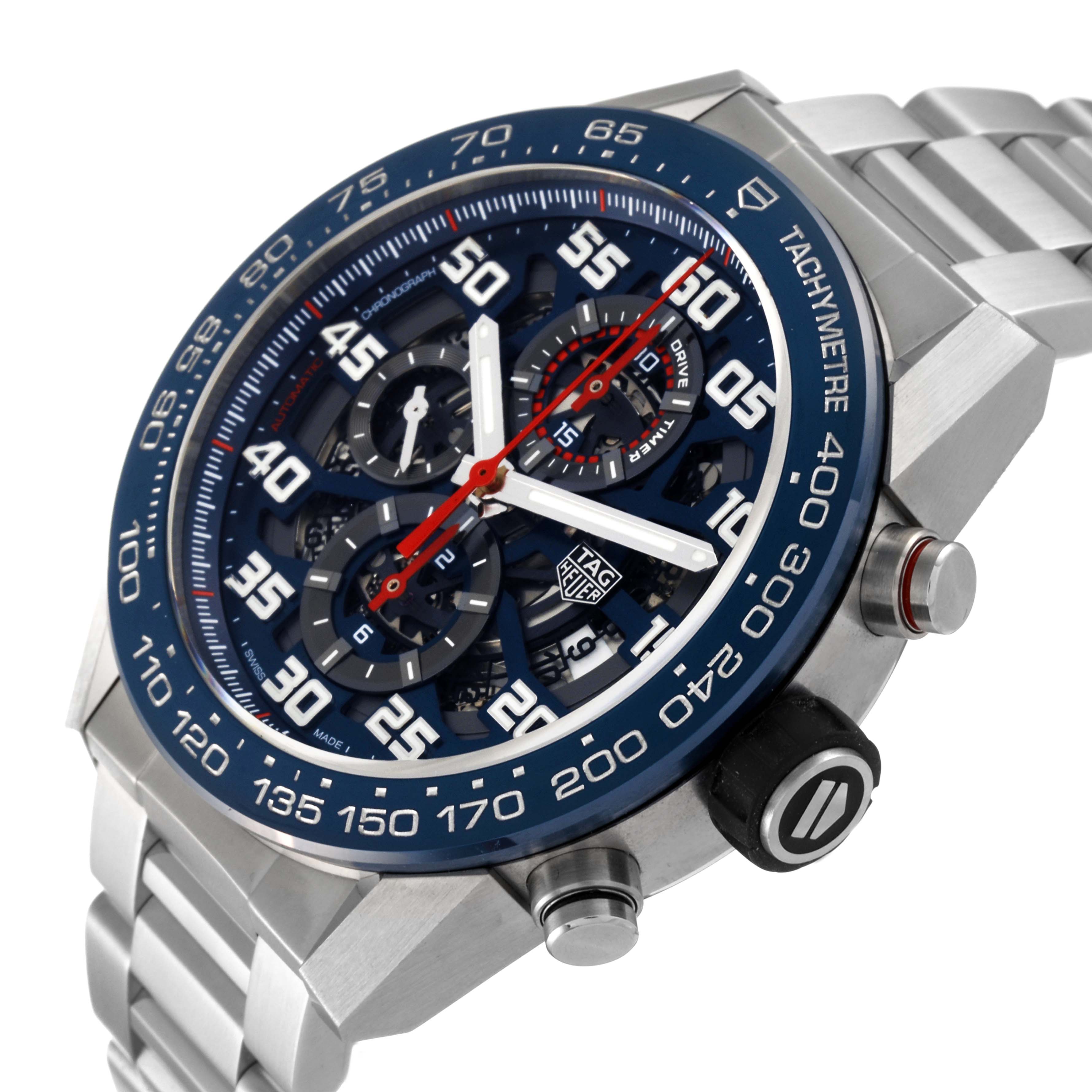 The image shows a Tag Heuer Carrera CAR2A1K.BA0703 Men's Stainless Steel Blue Dial CAR2A1K.BA0703 Men's Stainless Steel Blue Dial watch at an angle, highlighting its face, tachymeter bezel, and metal bracelet.