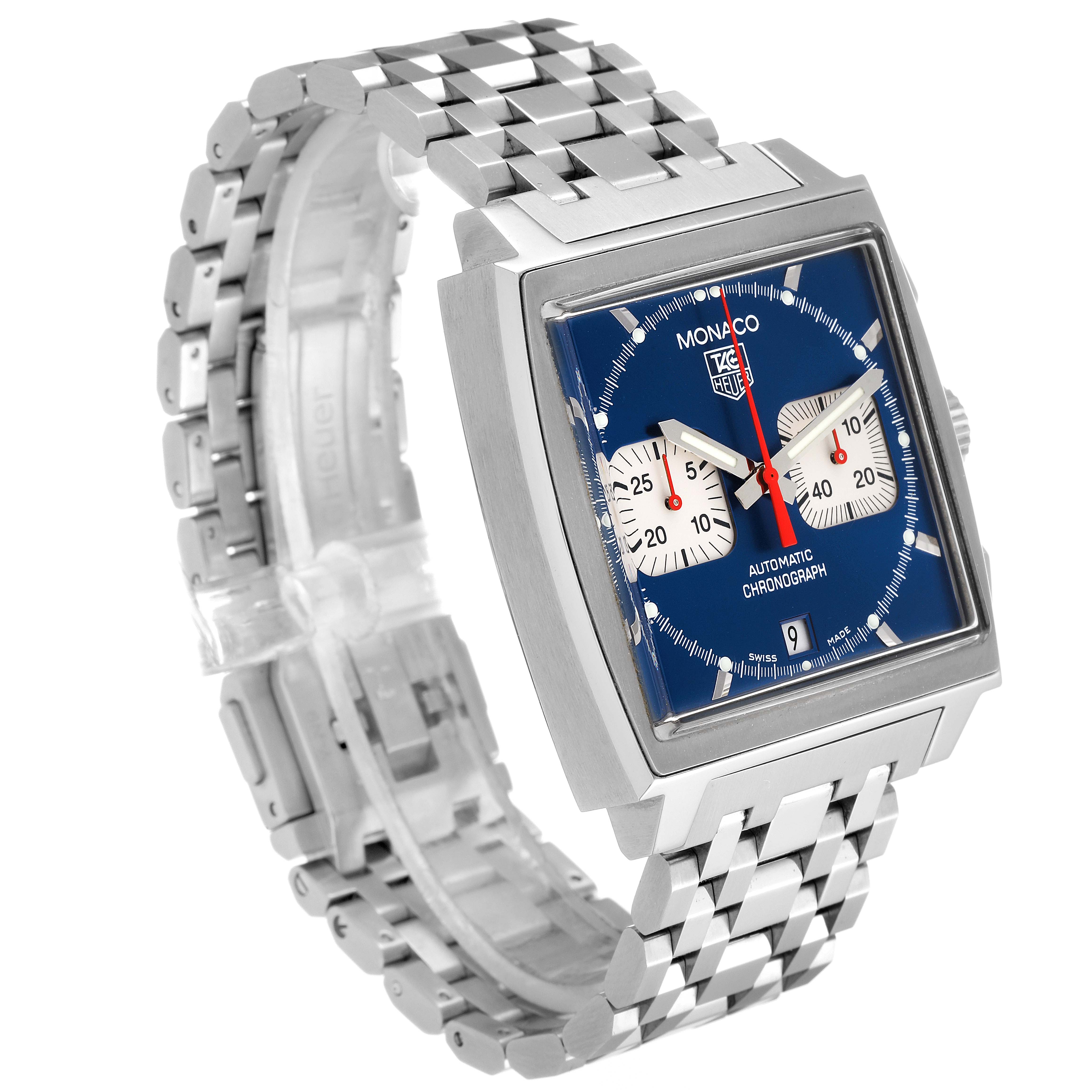 The image showcases a Tag Heuer Monaco CW2113.BA0780 Men's Stainless Steel Blue Dial CW2113.BA0780 Men's Stainless Steel Blue Dial watch from a left-front angle, highlighting its square case, blue dial, and metal bracelet.