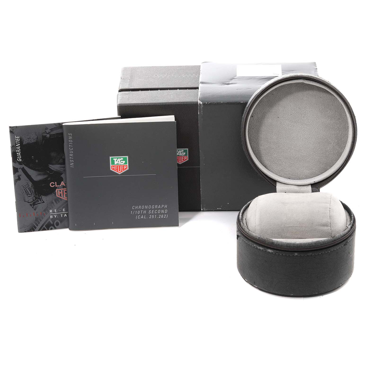The image shows the packaging, instructions, guarantee card, and case for a Tag Heuer Monza CR2110 Men's Stainless Steel Black Dial CR2110 Men's Stainless Steel Black Dial watch.