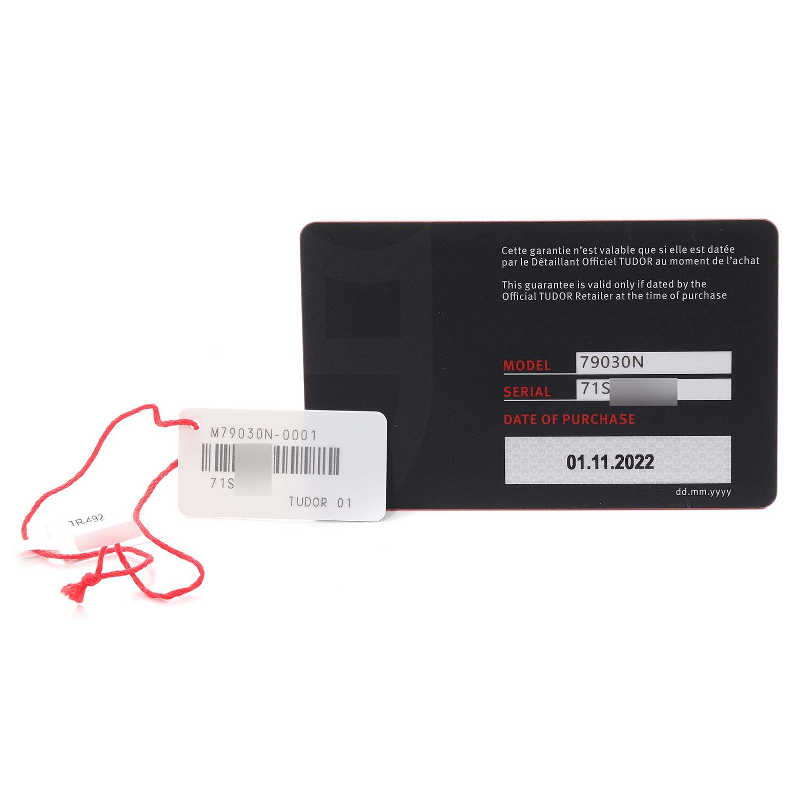 This image shows the warranty card and serial tag of a Tudor Heritage Black Bay M79030N-0001 Men
s Stainless Steel Black Dial M79030N-0001 Men
s Stainless Steel Black Dial model, displaying the model number and date of purchase.