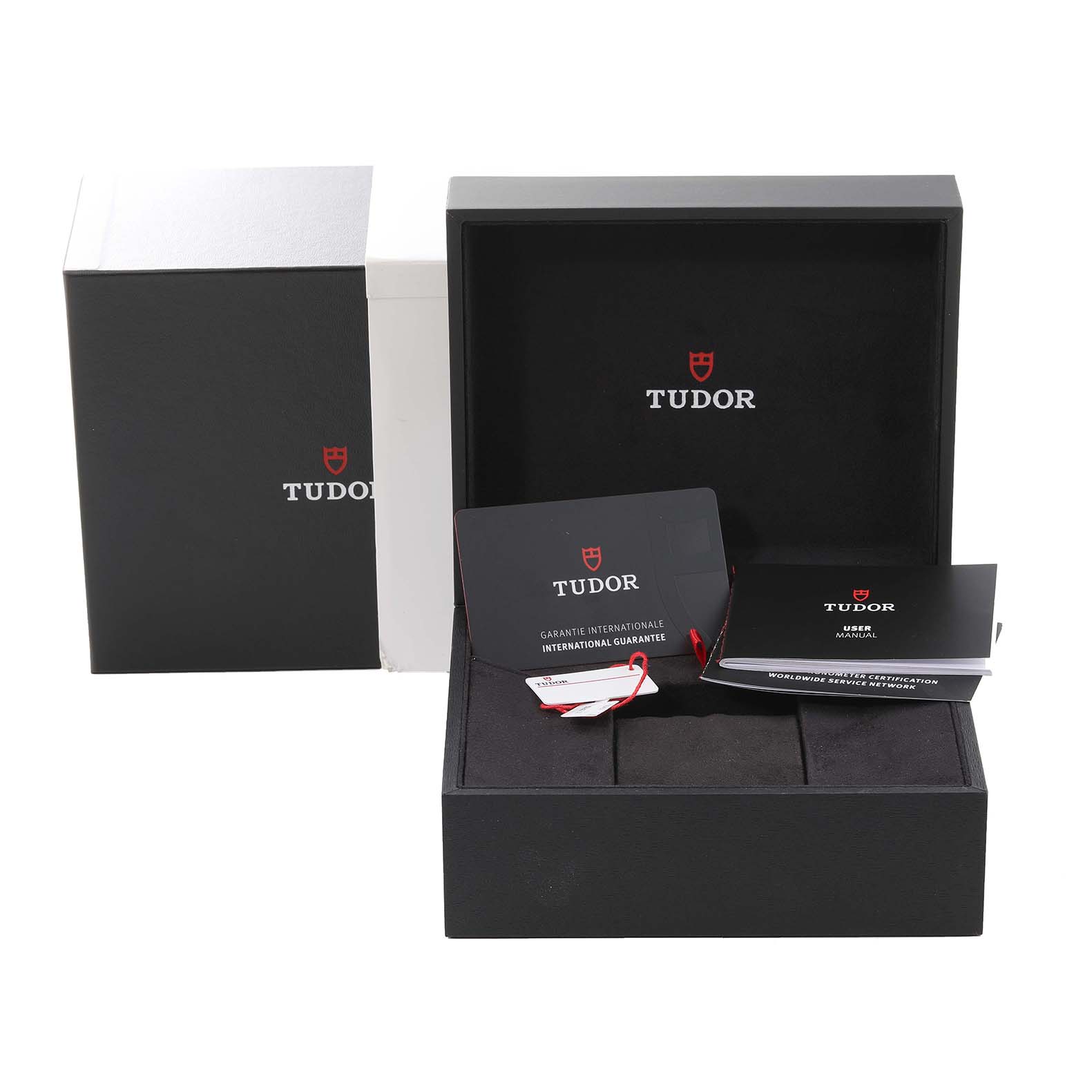 The image shows the open box of the Tudor Heritage Black Bay M79030N-0001 Men
s Stainless Steel Black Dial M79030N-0001 Men
s Stainless Steel Black Dial watch along with its warranty card and user manual.