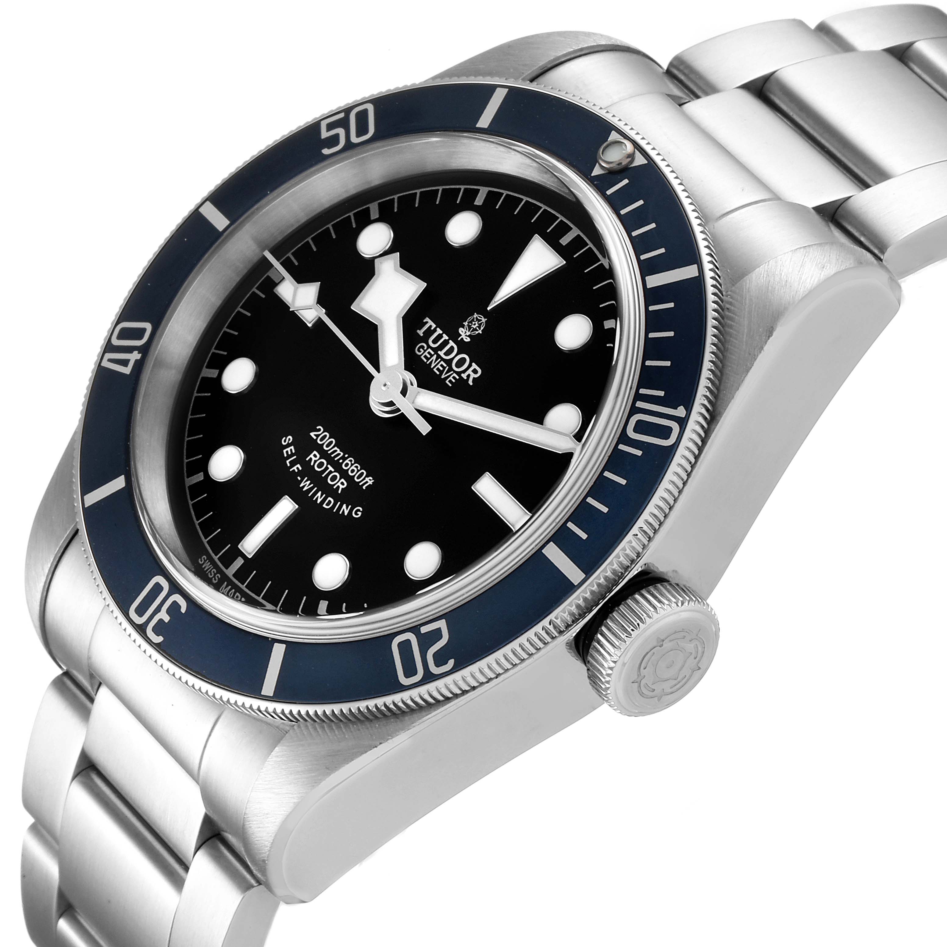 The watch shown is a Tudor Heritage Black Bay 79220 Men's Stainless Steel Black Dial 79220 Men's Stainless Steel Black Dial model, angled to display its face, bezel, crown, and part of its bracelet.