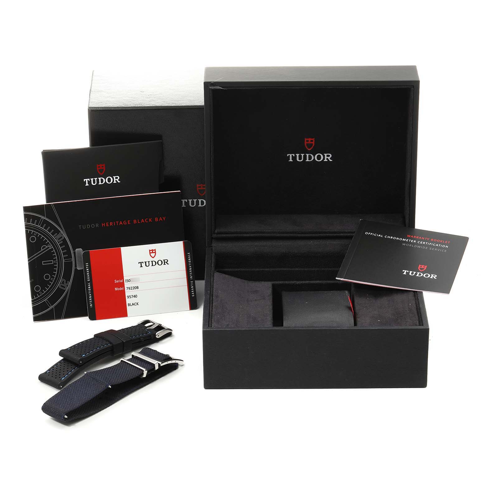 This image shows the packaging, warranty cards, instruction manuals, and additional straps for the Tudor Heritage Black Bay 79220 Men's Stainless Steel Black Dial 79220 Men's Stainless Steel Black Dial watch.