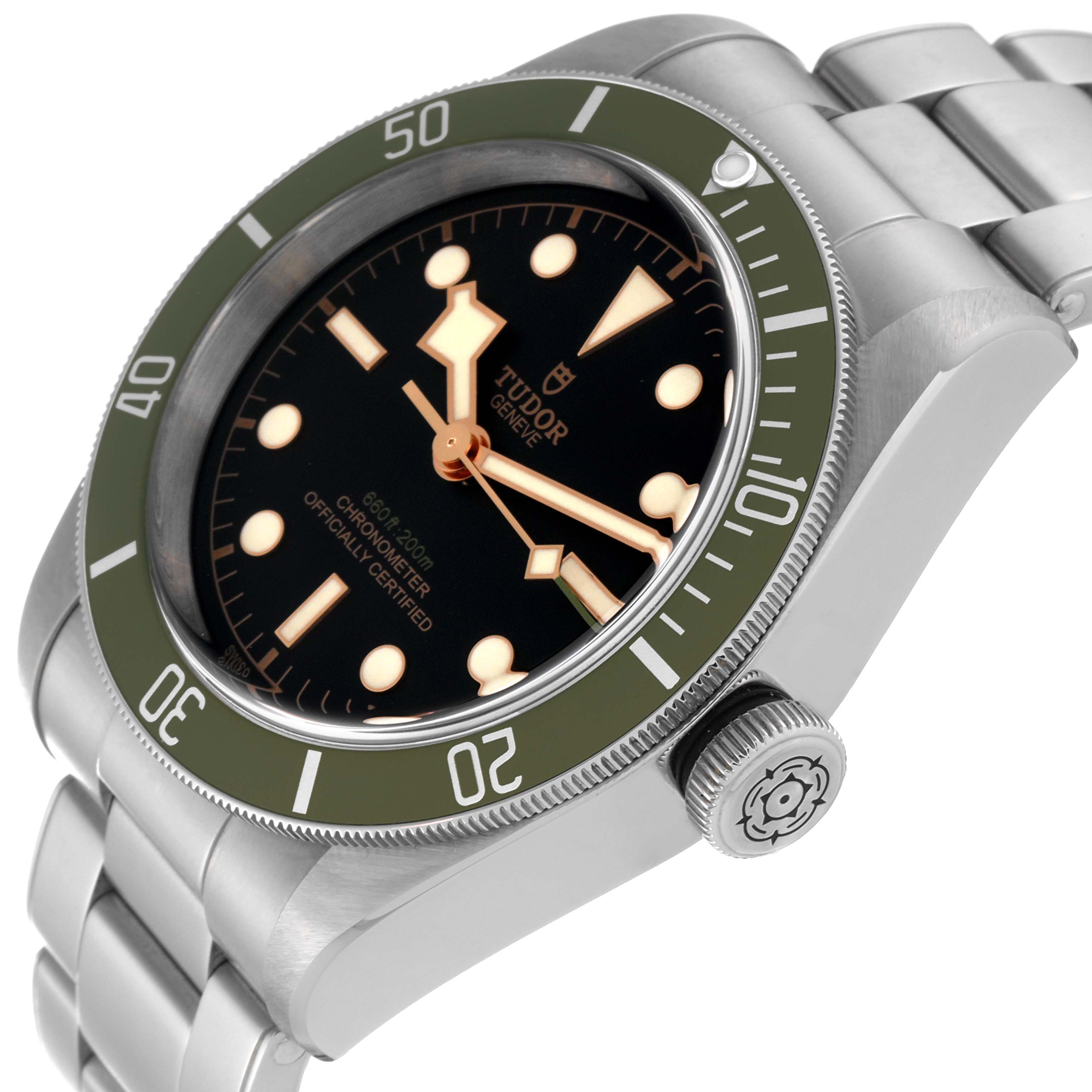 The Tudor Heritage Black Bay 79230G Men's Stainless Steel Black Dial watch is shown at an angled view highlighting the dial, bezel, crown, and bracelet.