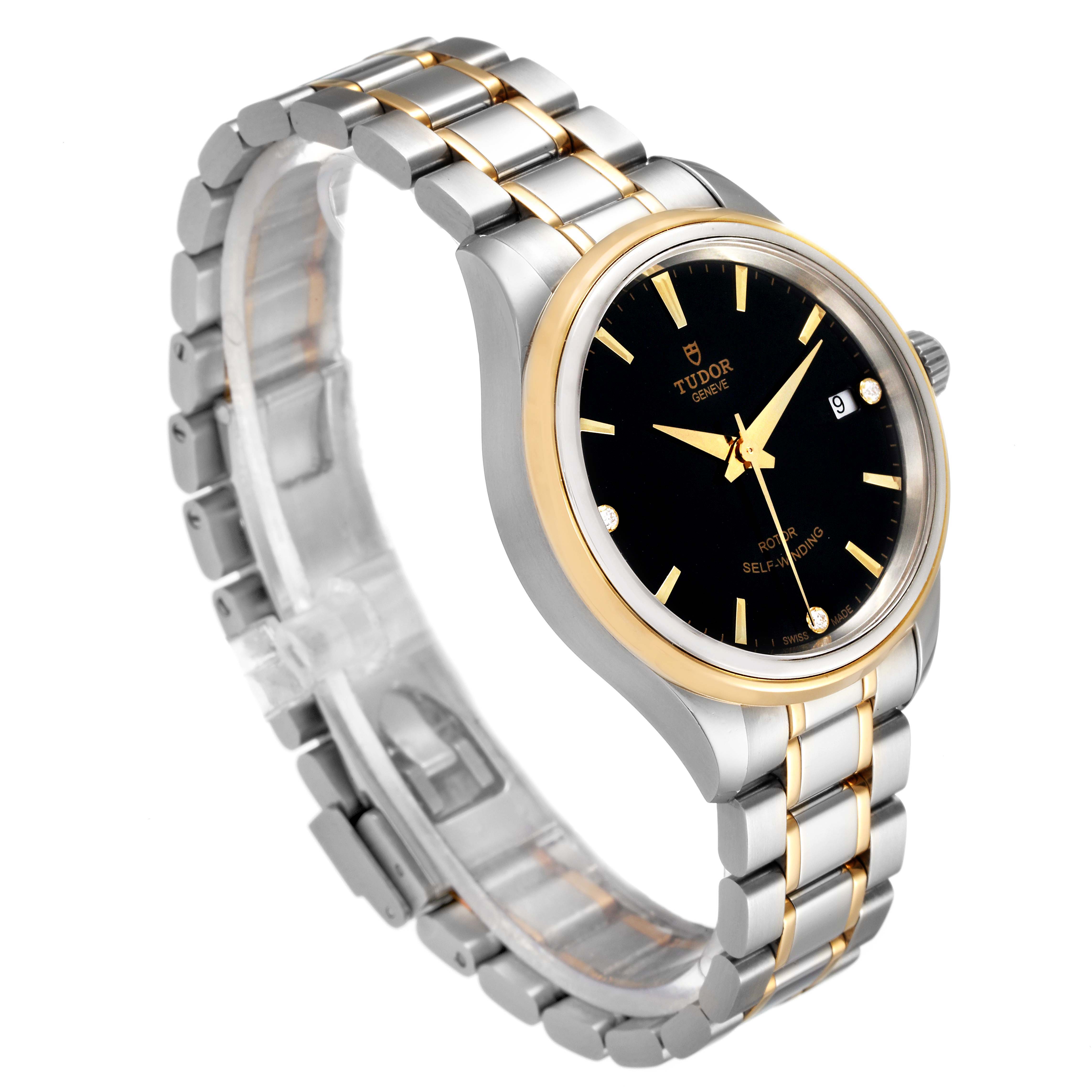 The Tudor Style M12303 Women
s Steel and Gold (two tone) Black Dial M12303 Women
s Steel and Gold (two tone) Black Dial model watch is shown at a side angle, displaying its black dial, two-tone bracelet, and bezel.