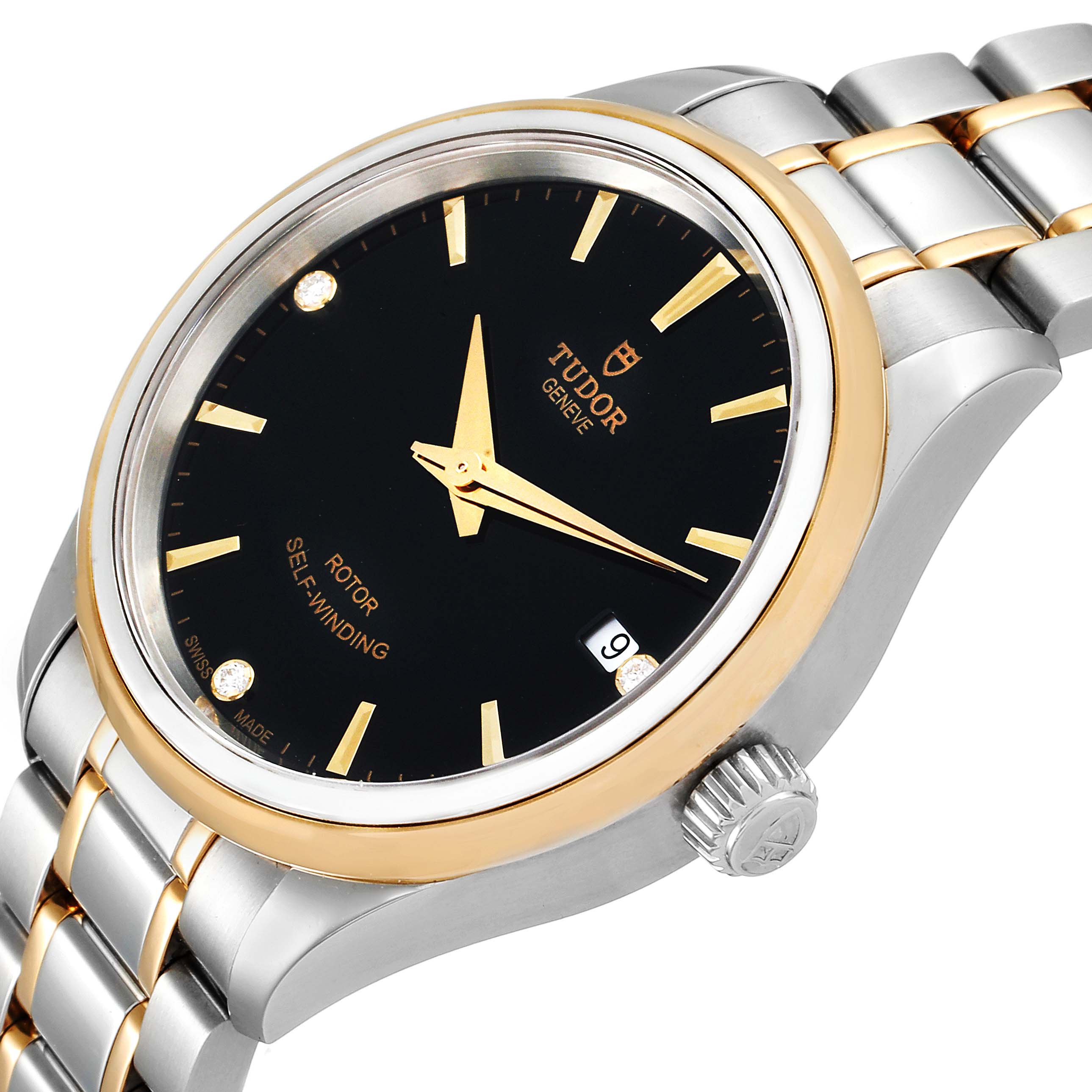 The image shows the Tudor Style M12303 Women
s Steel and Gold (two tone) Black Dial M12303 Women
s Steel and Gold (two tone) Black Dial model watch at an angle highlighting its black dial, gold markers, date window, and stainless steel and gold bracelet.