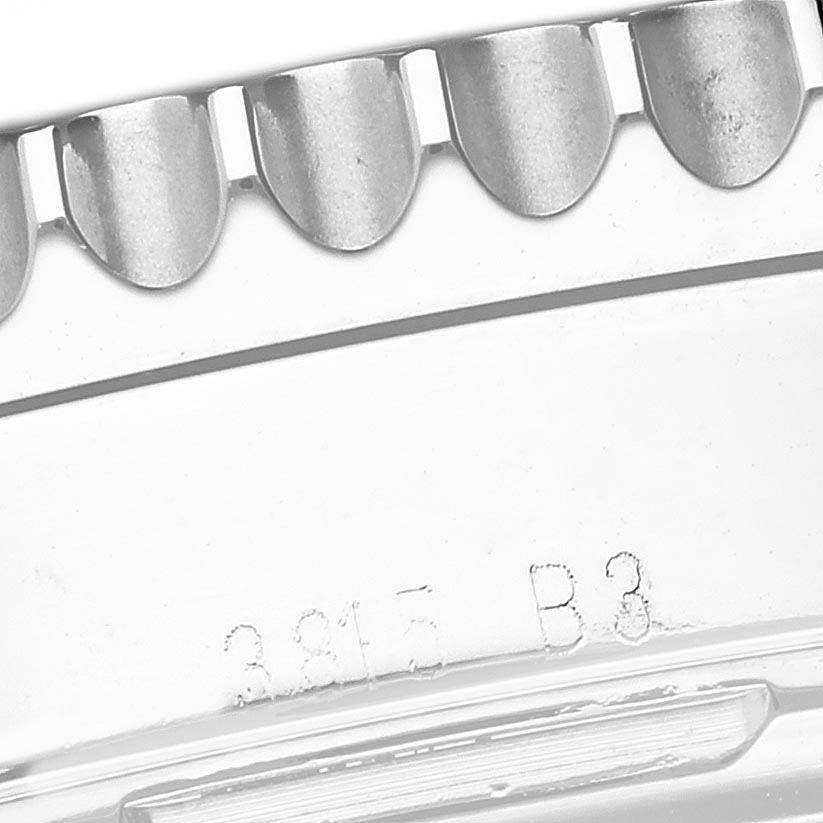 The image shows a close-up angle of the Breitling Navitimer AB0121 Men
s Stainless Steel Blue Dial AB0121 Men
s Stainless Steel Blue Dial
s bracelet links and some engraved markings.