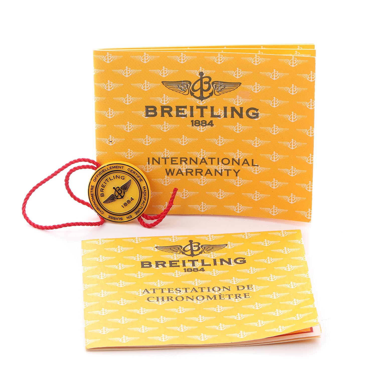 The image shows a Breitling Navitimer A35350 Men
s Stainless Steel Blue Dial A35350 Men
s Stainless Steel Blue Dial
s international warranty booklet and chronometer certificate with a branded tag.