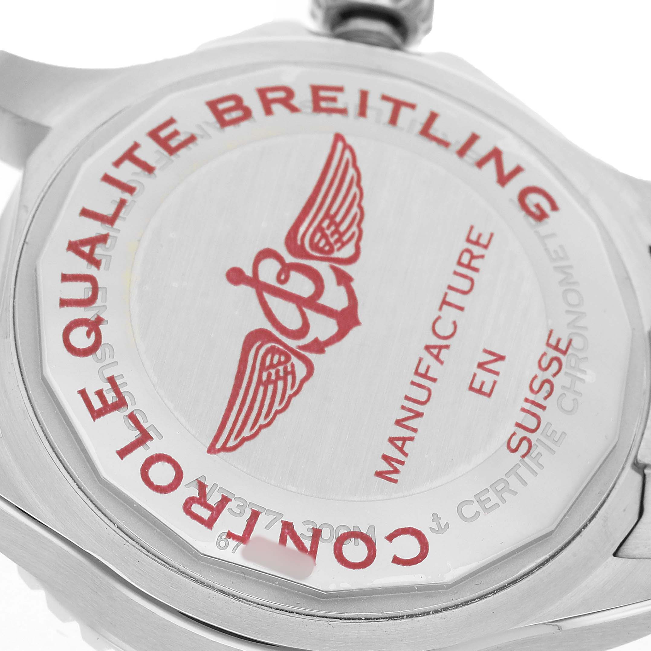 The image shows the case back of a Breitling Superocean A17377211C1A1 Men's Stainless Steel Blue Dial watch, highlighting engraved details and logos.