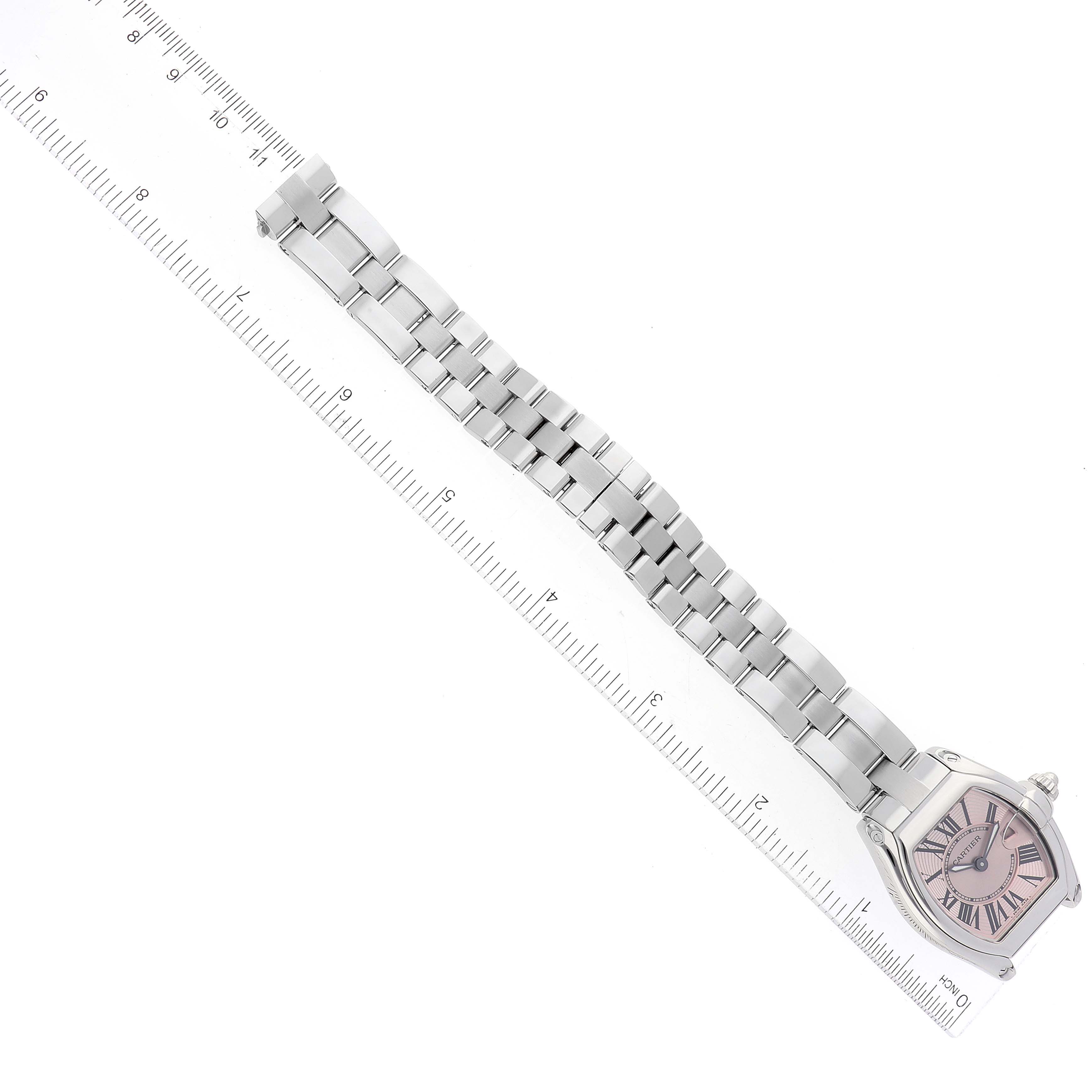 The image shows a Cartier Roadster W62017V3 Women's Stainless Steel Pink Dial W62017V3 Women's Stainless Steel Pink Dial watch with a full view of the face, and metal bracelet laid flat next to a ruler for measurement.
