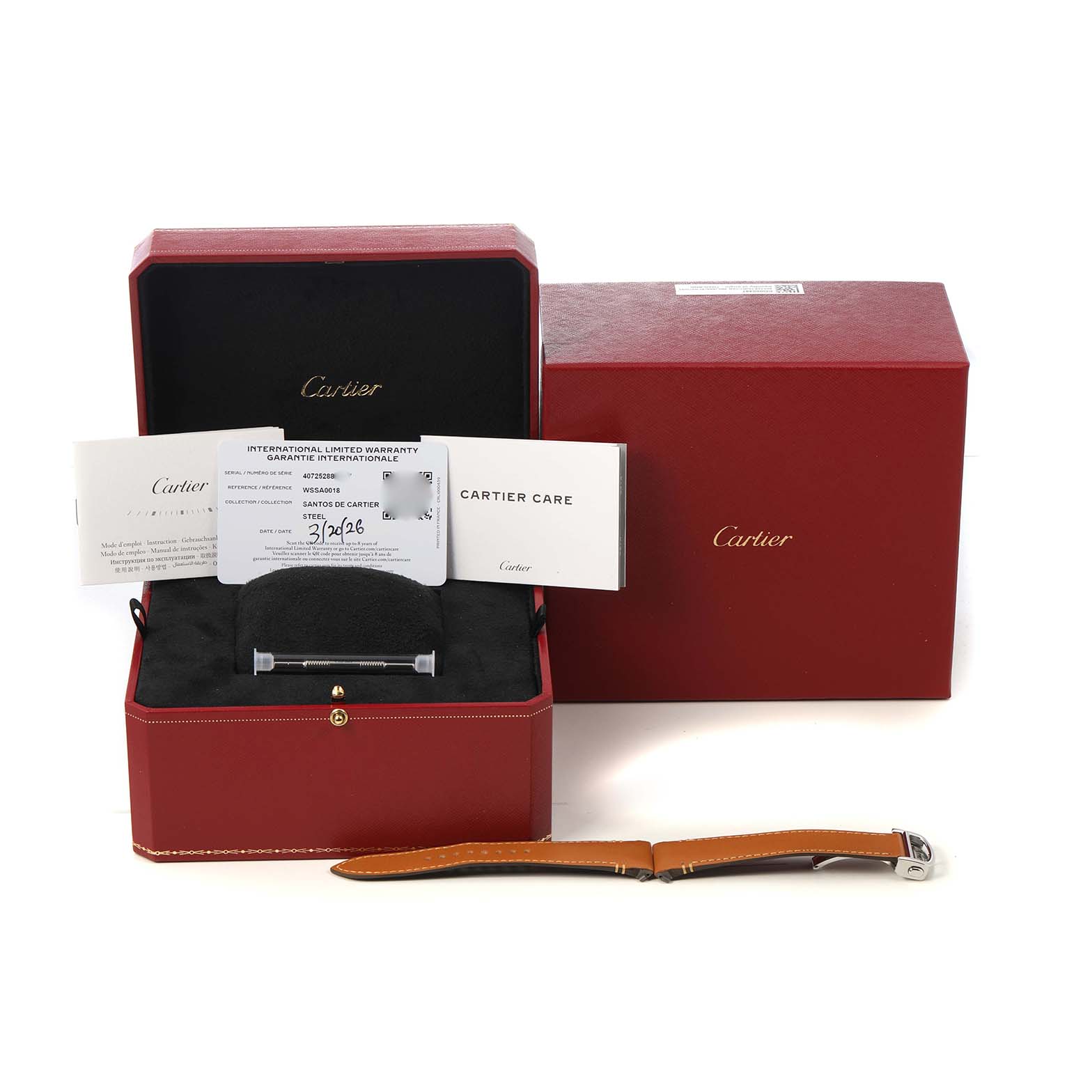 The image shows a Cartier Santos WSSA0018 Men's Stainless Steel Silver Dial box with warranty card, documents, a tool, and an extra strap displayed from the front.