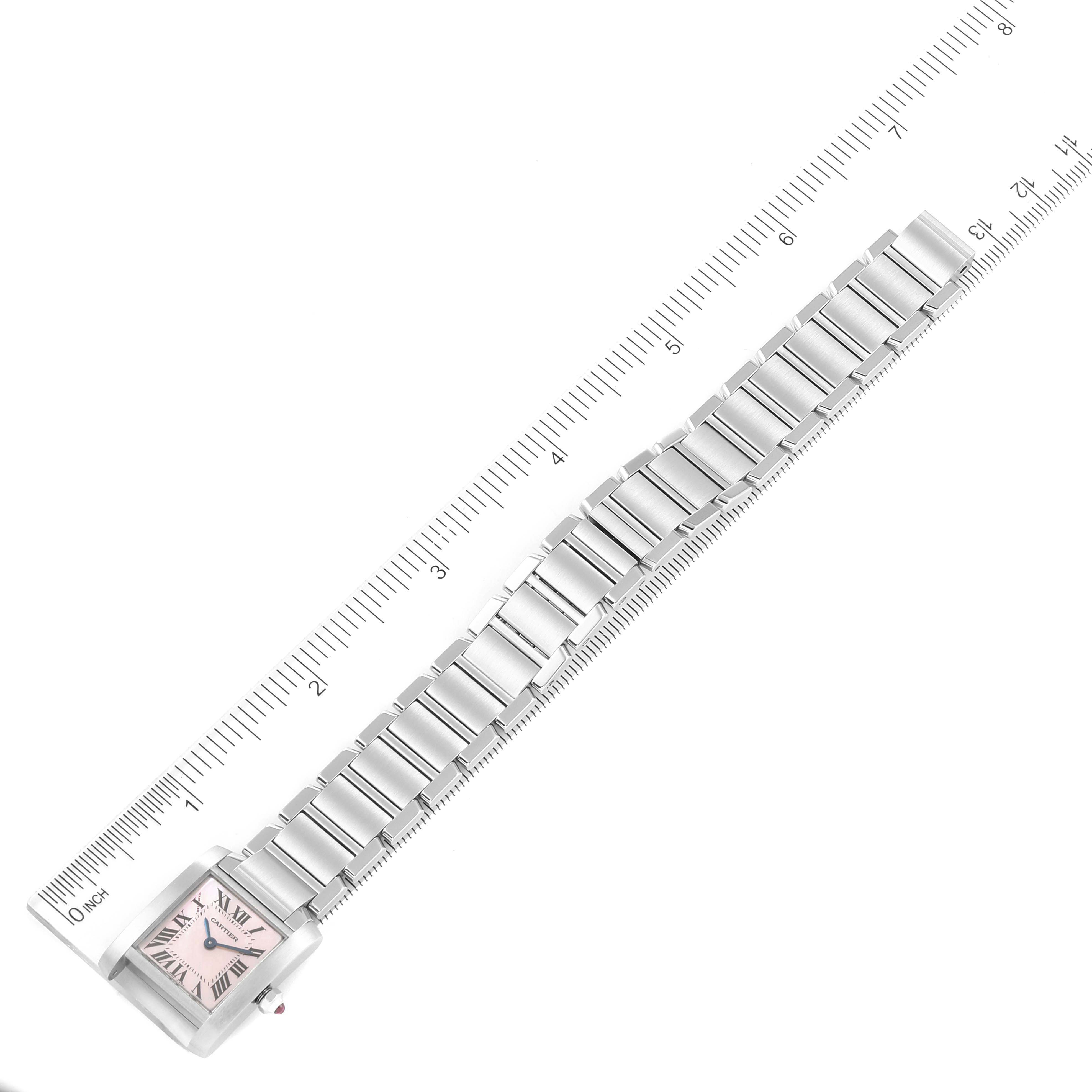 The image shows the Cartier Tank Francaise W51028Q3 Women
s Stainless Steel Mother of Pearl Dial W51028Q3 Women
s Stainless Steel Mother of Pearl Dial watch in a top-down angle, highlighting its face and metal bracelet partially measured by a ruler.