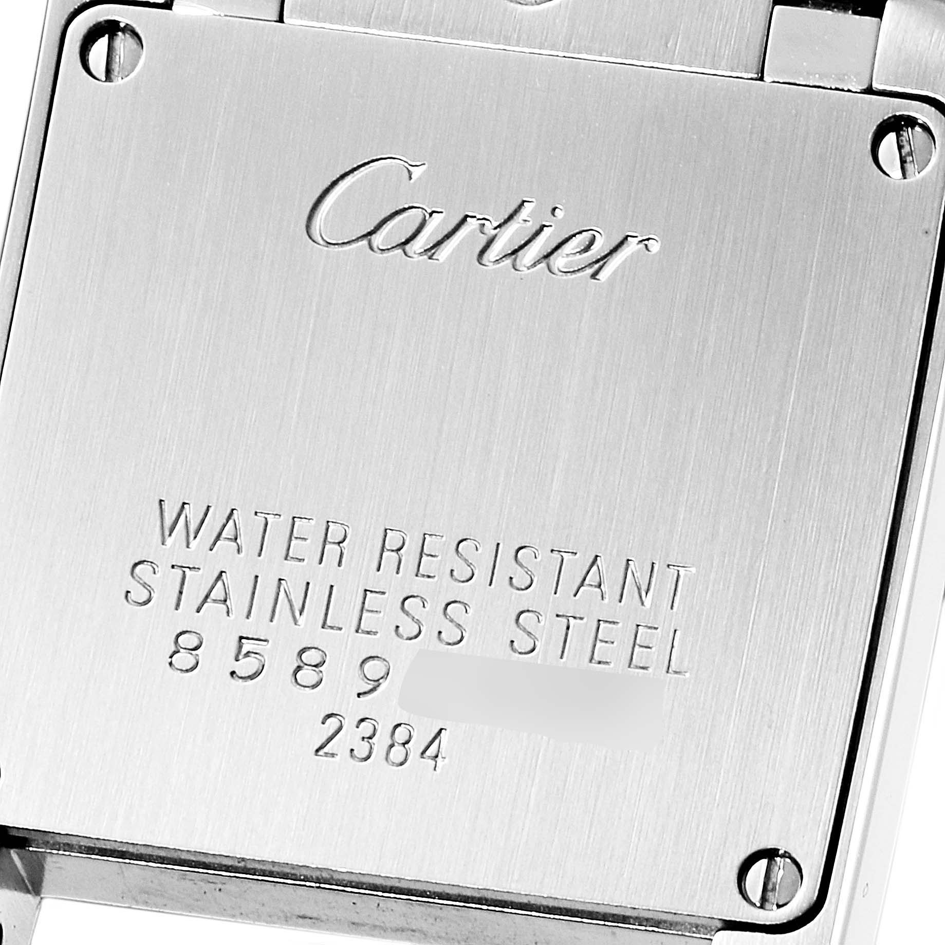 This is a close-up view of the back case of a Cartier Tank Française watch, showing the brand, model, and material details.