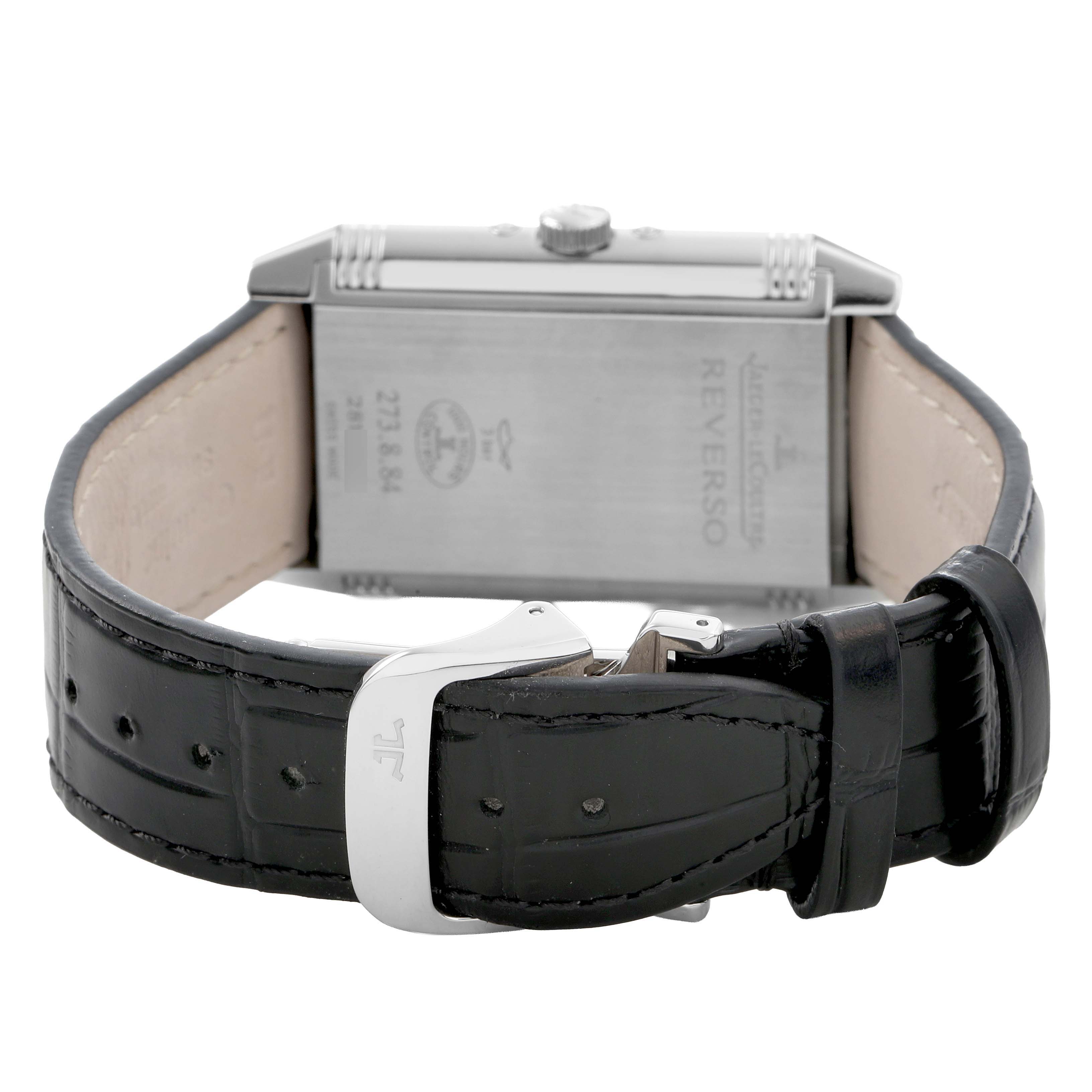 The image shows the Jaeger LeCoultre Reverso 273.8.84 Q3758420 Men's Stainless Steel Silver Dial watch from the back, focusing on the case, buckle, and leather strap.