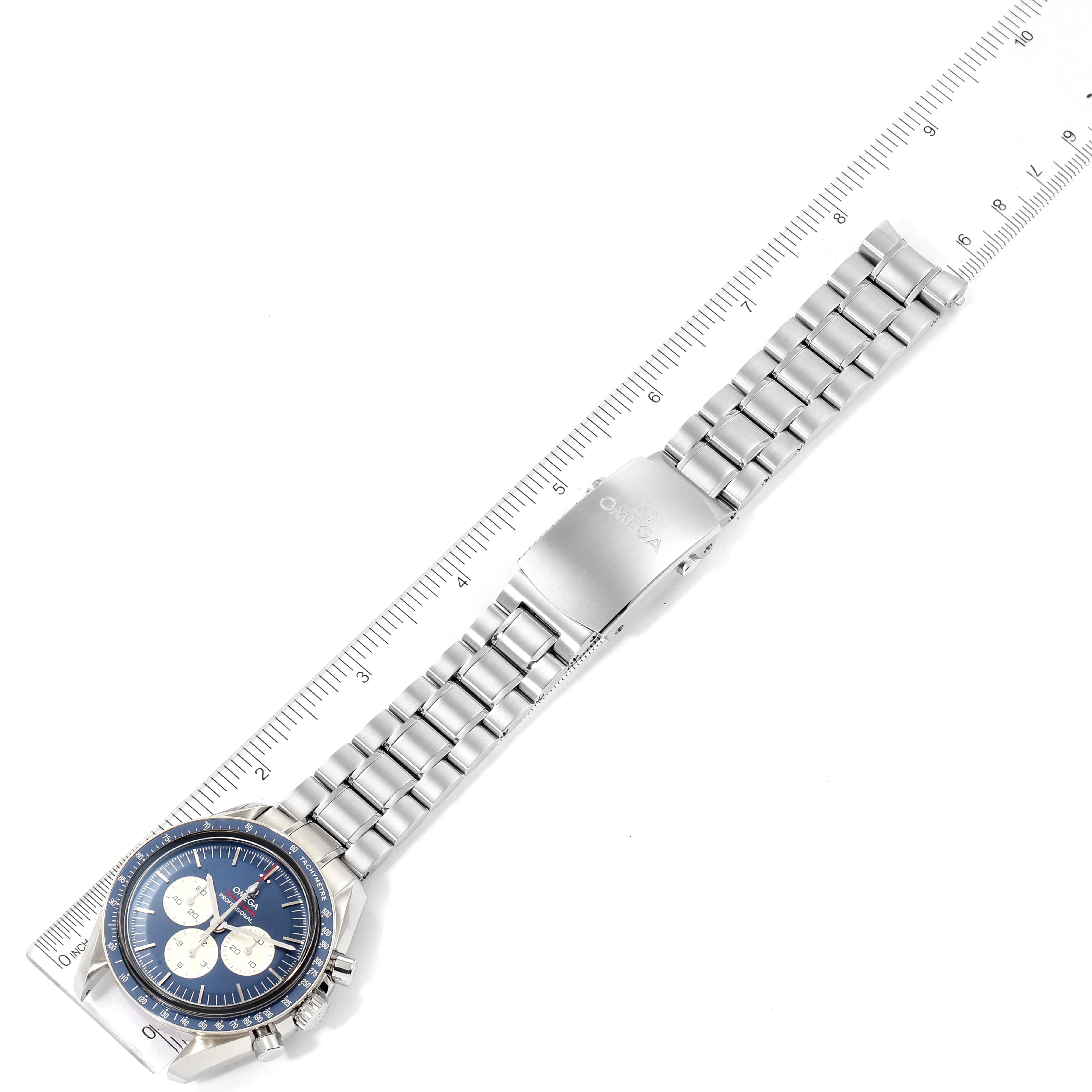 The Omega Speedmaster 522.30.42.30.03.001 Men's Stainless Steel Blue Dial 522.30.42.30.03.001 Men's Stainless Steel Blue Dial watch is shown from a top-down angle with a ruler placed beside it.
