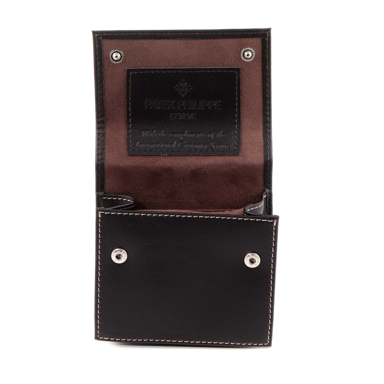 This image shows a Patek Philippe Complications 5230R Men's Rose Gold Grey Dial 5230R Men's Rose Gold Grey Dial model watch's leather case, open to reveal its interior.