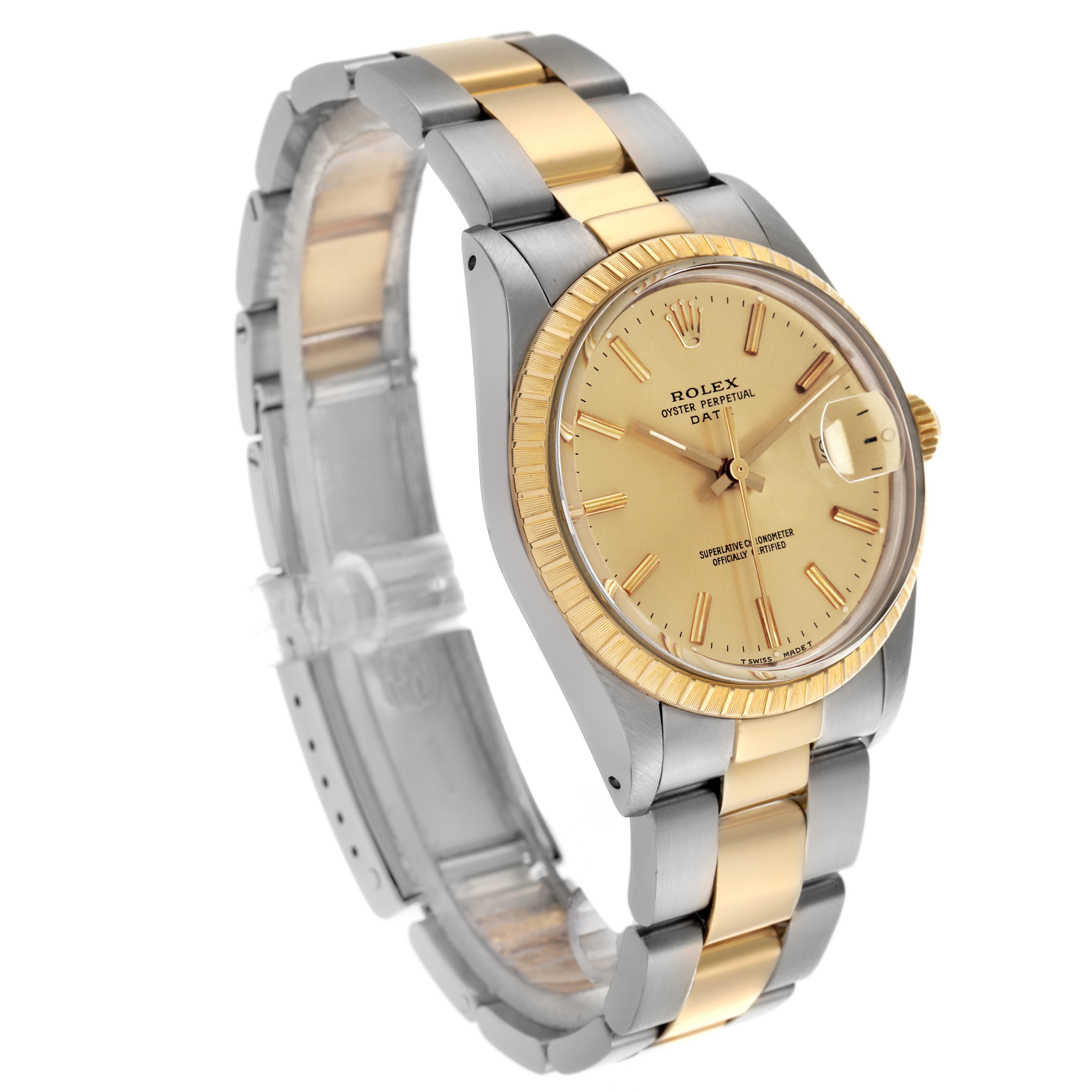 The Rolex Date 15053 Men
s Steel and Gold (two tone) Champagne Dial 15053 Men
s Steel and Gold (two tone) Champagne Dial watch is shown at a slight angle, displaying its two-tone bracelet, fluted bezel, and dial with a date window.