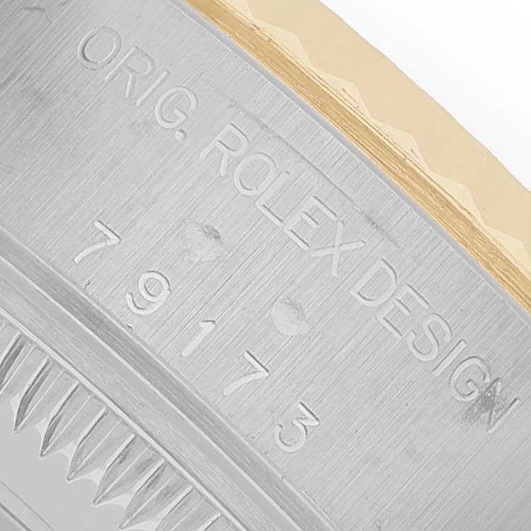 The image shows a close-up of the case side and bezel of the Rolex Datejust 79173 Women's Steel and Gold (two tone) Mother of Pearl Dial, highlighting the model number and design engraving.