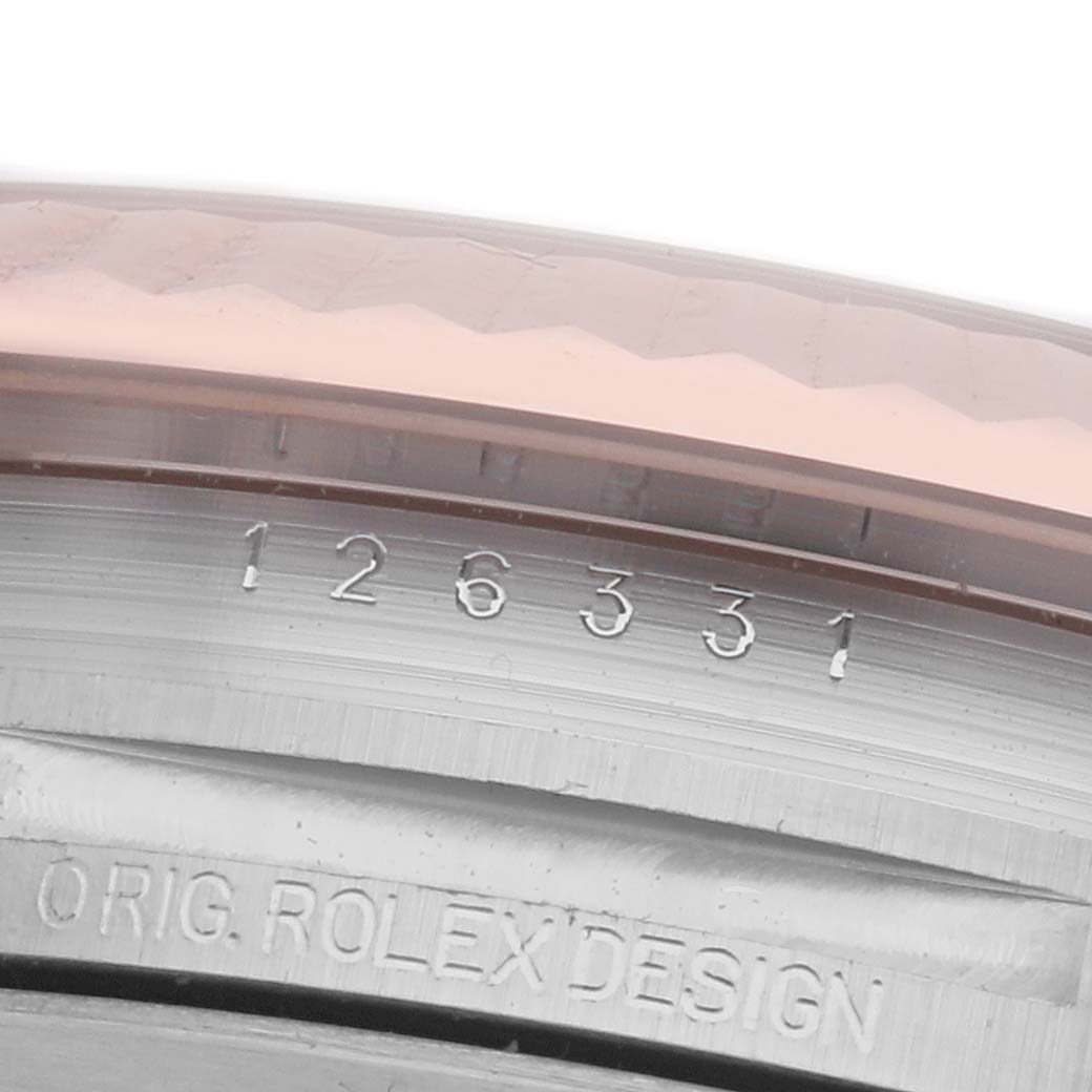 The image shows a close-up of the side engraving details on the bezel and case of a Rolex Datejust 41 126331 Men
s Steel and Gold (two tone) Brown Dial 126331 Men
s Steel and Gold (two tone) Brown Dial.