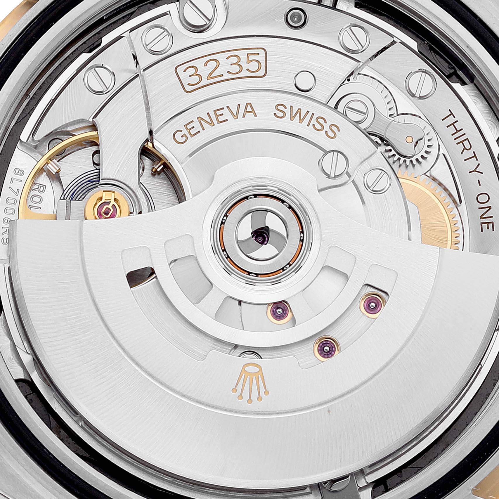 This image shows a close-up view of the movement mechanism of a Rolex Datejust 41 126303 Men's Steel and Gold (two tone) Black Dial 126303 Men's Steel and Gold (two tone) Black Dial model, highlighting the intricate details of the watch's internal components.
