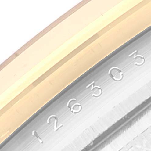 The image shows a close-up of the rehaut with part of the serial number and the gold bezel of a Rolex Datejust 41 126303 Men's Steel and Gold (two tone) Black Dial 126303 Men's Steel and Gold (two tone) Black Dial watch.