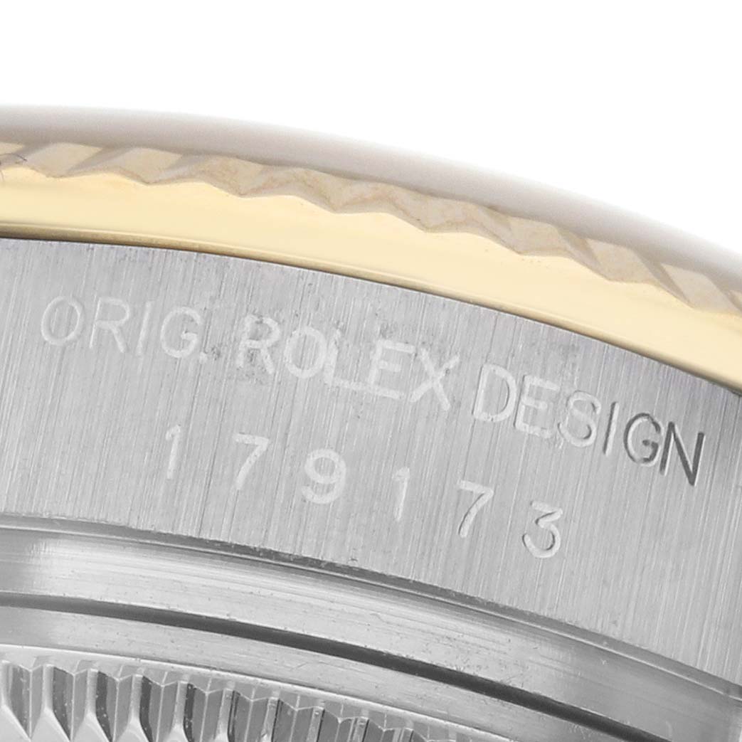 The image shows a close-up of the side engraving on a Rolex Datejust 179173 Women
s Steel and Gold (two tone) Silver Dial 179173 Women
s Steel and Gold (two tone) Silver Dial, highlighting the model number and "Orig. Rolex Design" text.