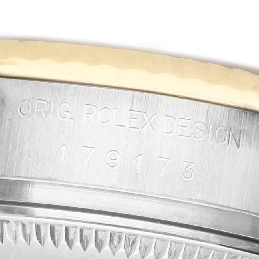 The image shows the side of a Rolex Datejust 179173 Women's Steel and Gold (two tone) Mother of Pearl Dial, highlighting the engraved case and part of the bezel.