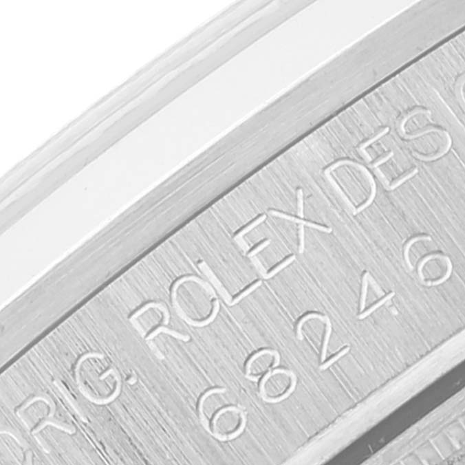This image shows a close-up of the engraved details on the inner bezel of a Rolex President 68246 Women's Platinum Silver Dial 68246 Women's Platinum Silver Dial model watch.
