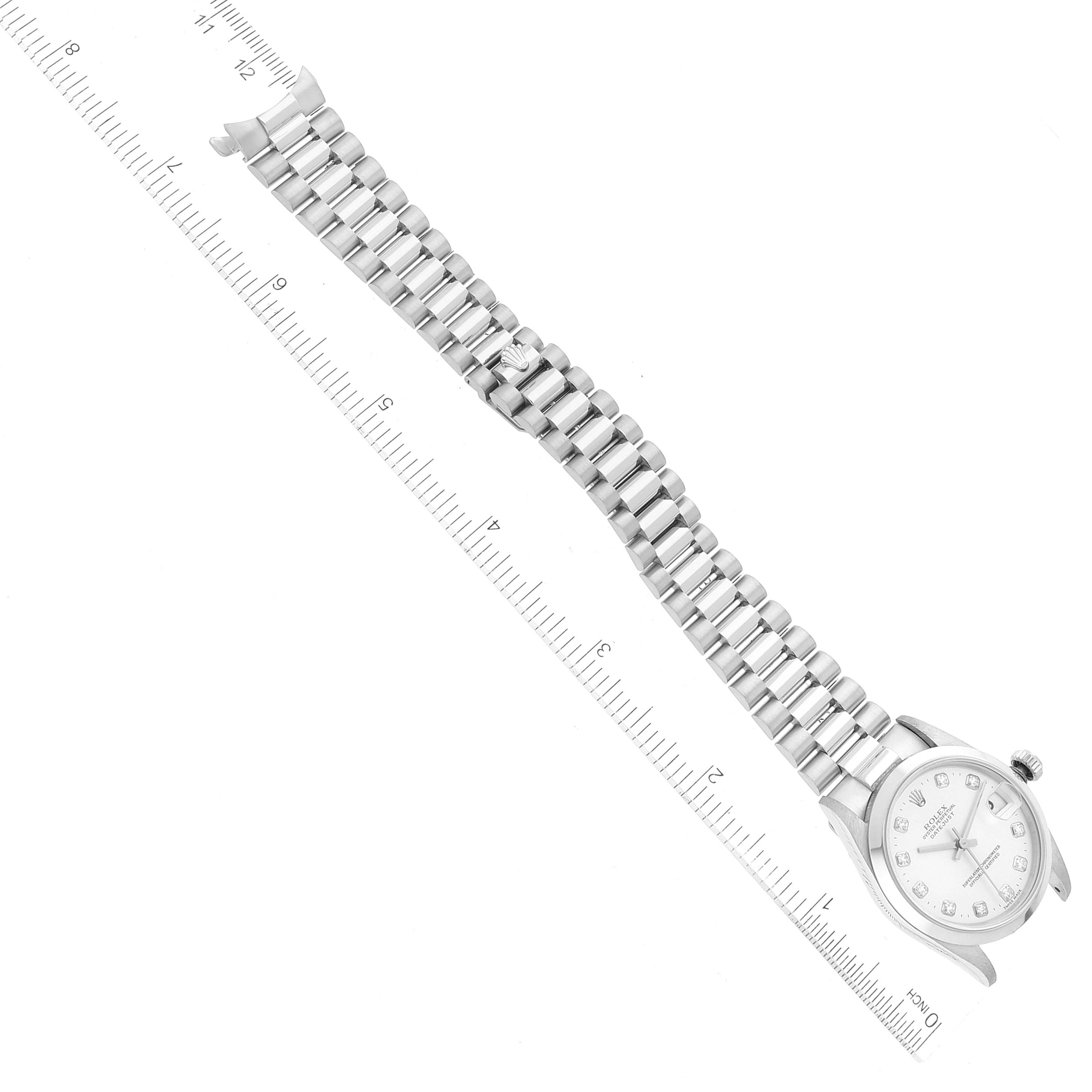 The image shows a top-down view of the Rolex President 68246 Women's Platinum Silver Dial 68246 Women's Platinum Silver Dial model watch, with the complete bracelet and face visible, next to a ruler for scale.