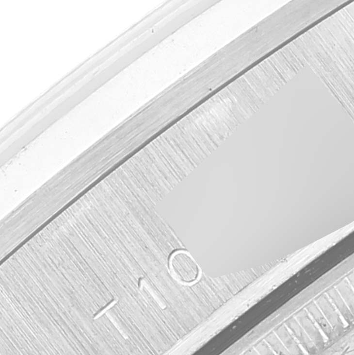 This image shows a partial close-up of the bezel of a Rolex President 68246 Women's Platinum Silver Dial 68246 Women's Platinum Silver Dial model watch.
