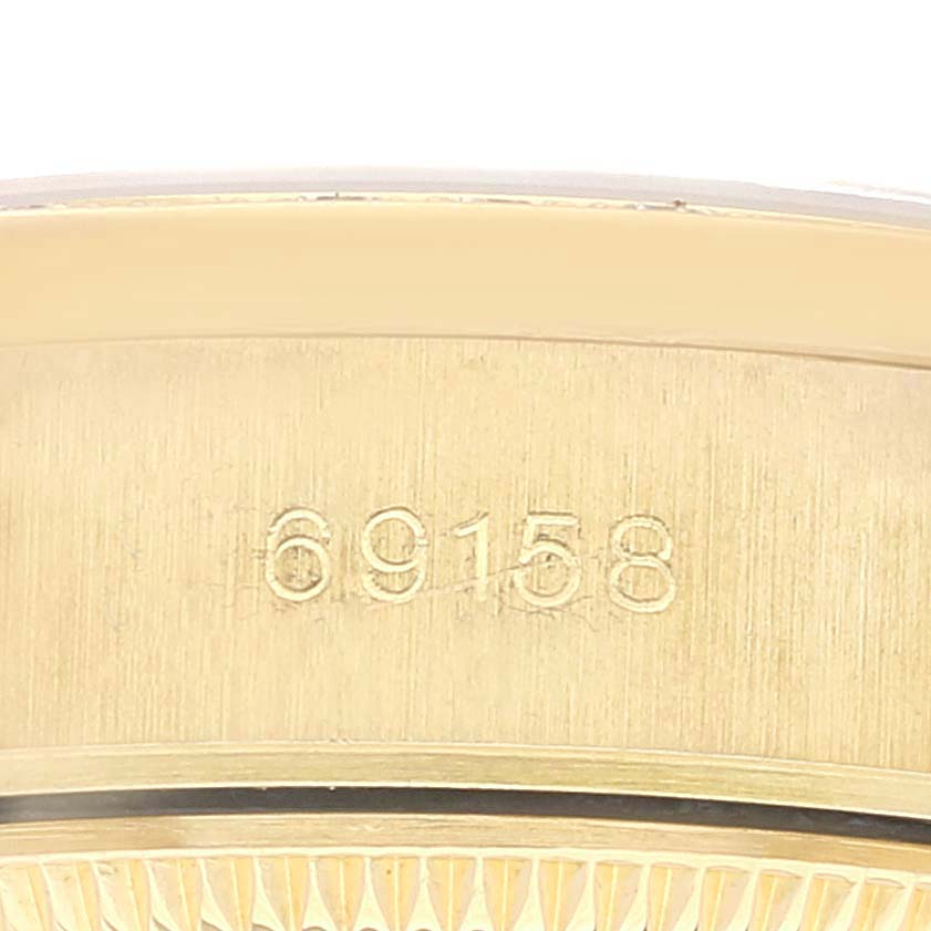 This close-up image shows the model number "69158" engraved on the case of a Rolex President 69158 Women
s Yellow Gold Champagne Dial 69158 Women
s Yellow Gold Champagne Dial watch.