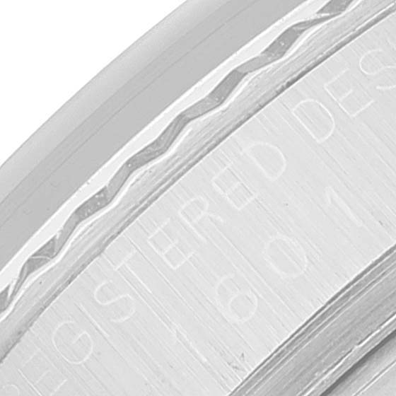 The image shows a close-up of the engraved bezel or case edge of the Rolex Vintage Collection 1601 Men's Stainless Steel Silver Dial 1601 Men's Stainless Steel Silver Dial watch.