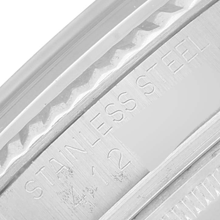 The image shows a close-up of the stainless steel bezel with engravings of a Vintage Collection Rolex watch.