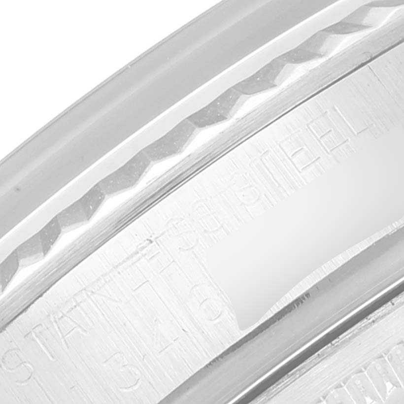 This close-up image shows the engraved case back edge of the Vintage Collection model by Rolex, highlighting its stainless steel construction.